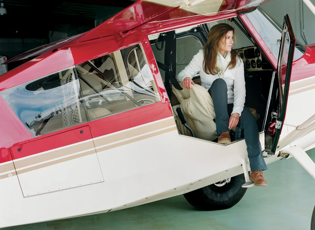 lori_olson_women_in_wyoming_chapter_2_filling_the_void_backcountry_pilot_with_papa_charlie_her_plane_in_pilots_seat.jpg