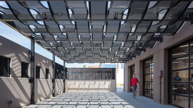 The light casts shadows with interesting helix patterns through the patio overhang.