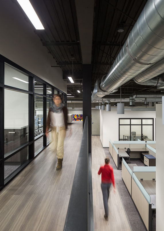 Here you can see the two separate levels in the office. The conference rooms are on the mezzanine level, and the workstations and offices are on the first level.