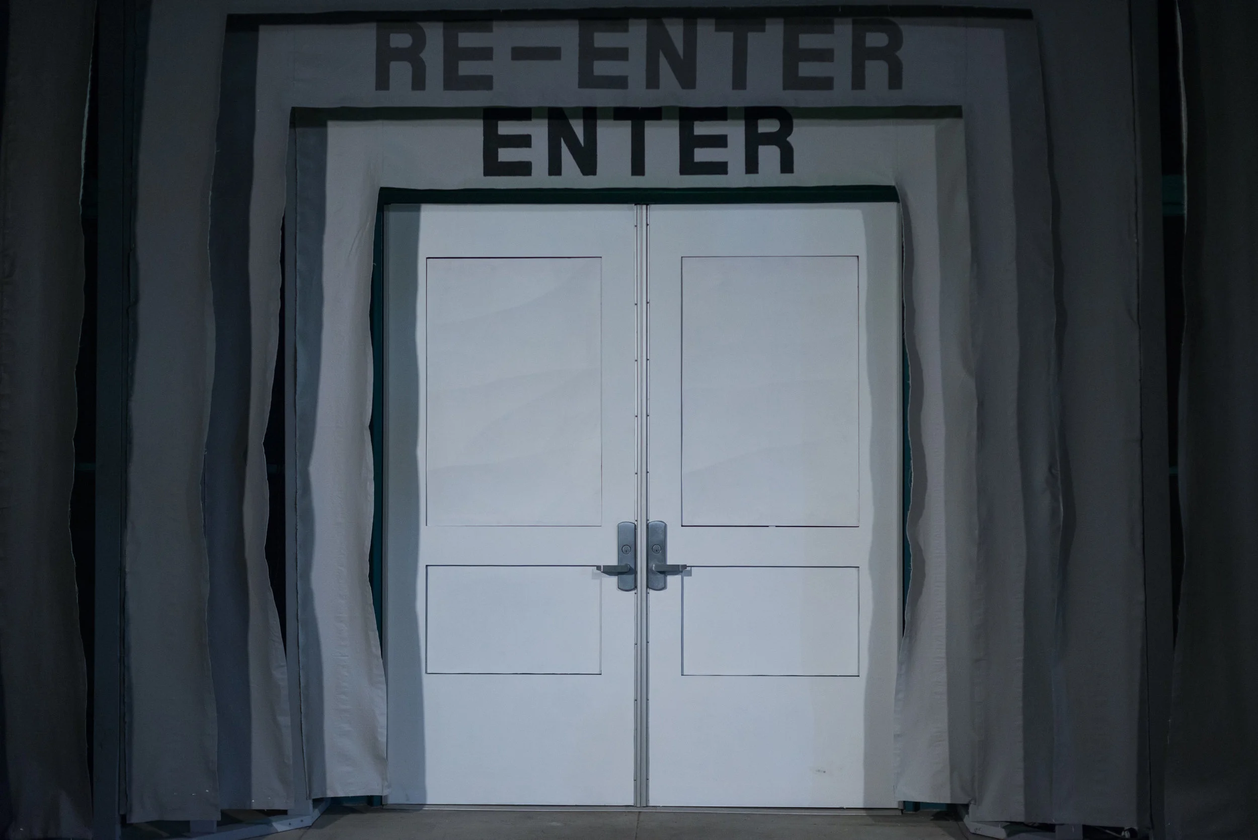 ENTER-RE-ENTER (proscenium) , A series of 5 fabric banners were built into the threshold of the site. A pattern of ascending gray coloring radiated from the white door, each banner adorned with the text ENTER alternating with the text RE-ENTER, radiating outward in a conversely sequenced gray scale so that the center banner has the same color grey for the text as it does for the background, rendering it nearly imperceptible.