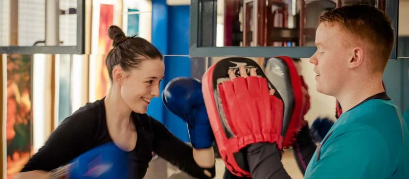 Gym member enjoying her personal trainer class