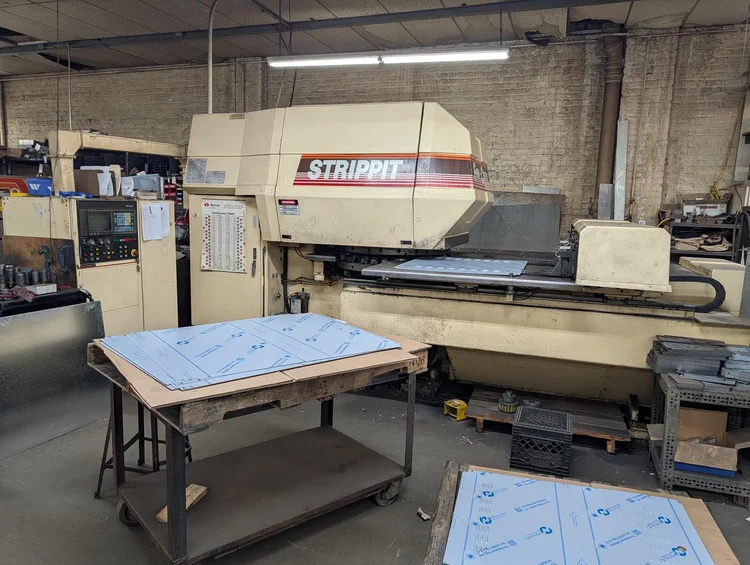 CNC turret punch press with film-coated sheets ready for punching