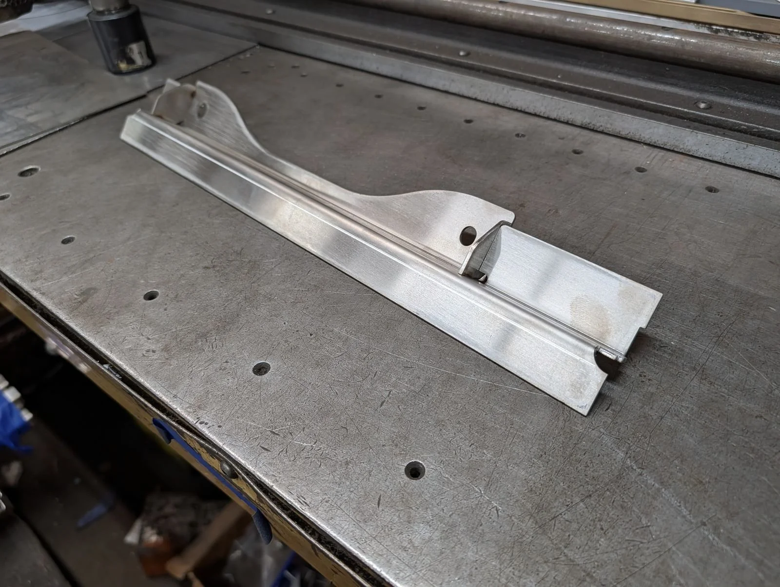 Formed stainless steel channel bracket with a cut profile
