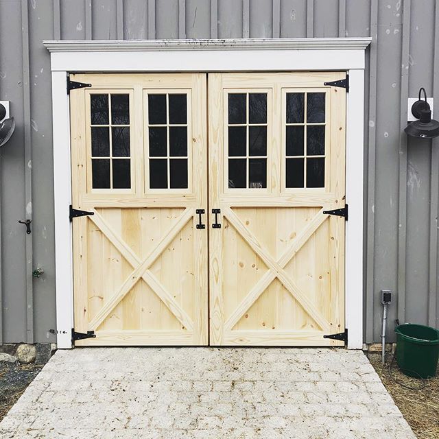 Double swinging door on an well-loved barn. The stone walk adds a perfect touch! #barndoors #barndepot #handcrafted #madeinmassachusetts #madeinnewengland #wooddoors