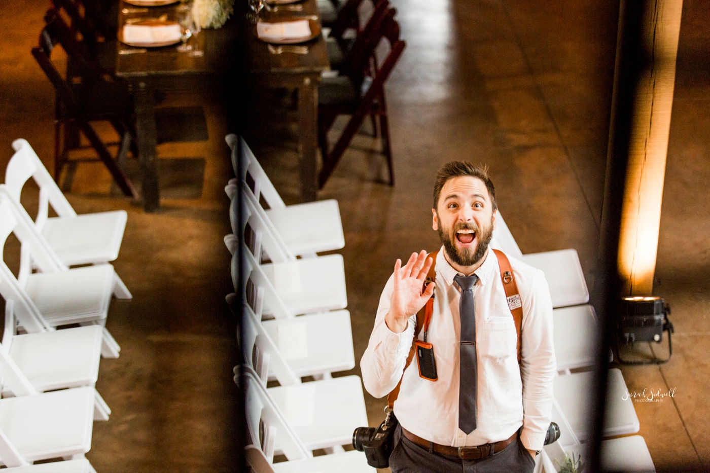 A man waves from from below.