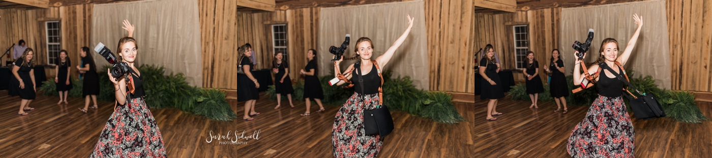 A photographer dances on a dance floor.