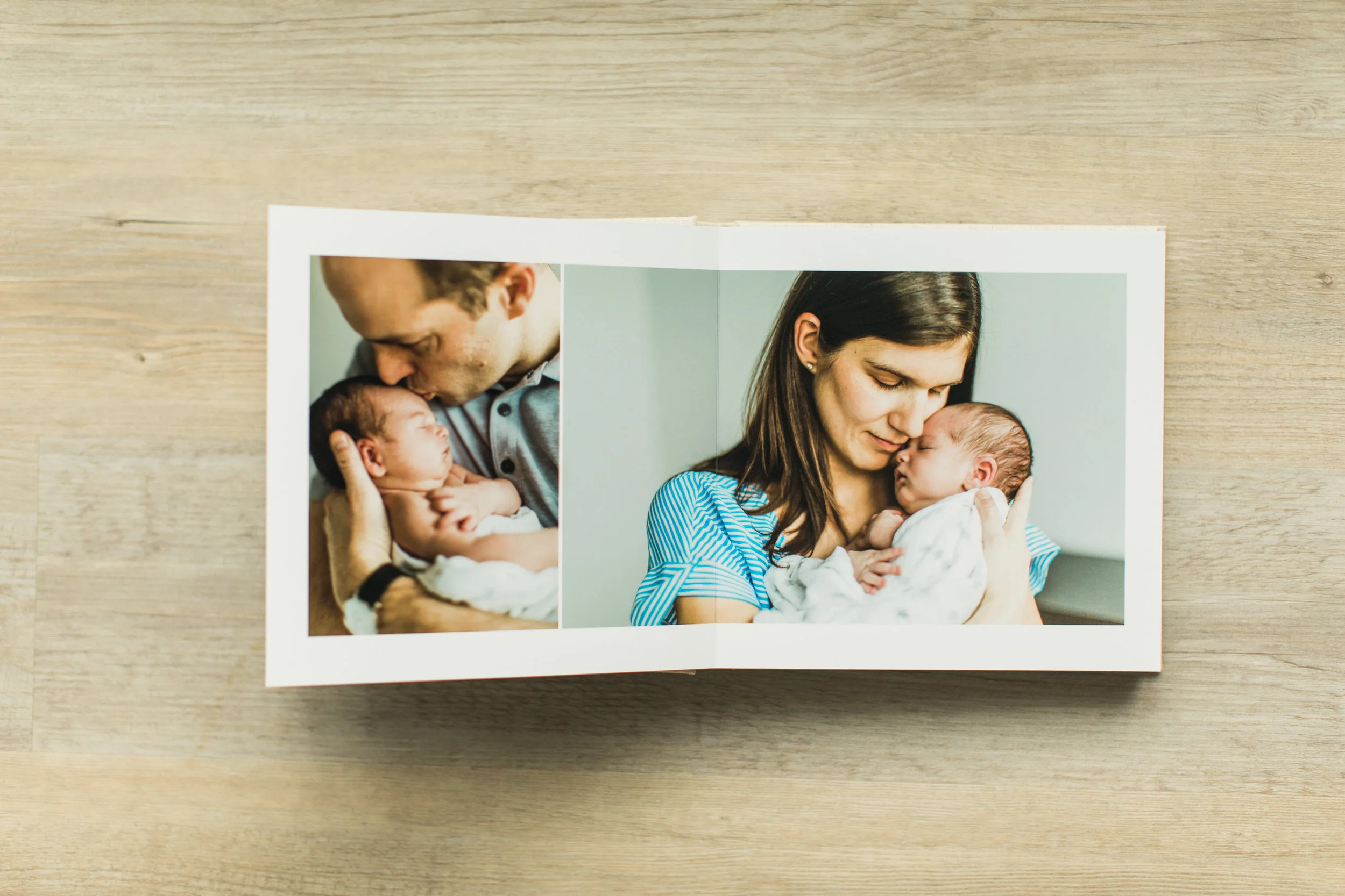 The inside pages of a baby photo album are shown.
