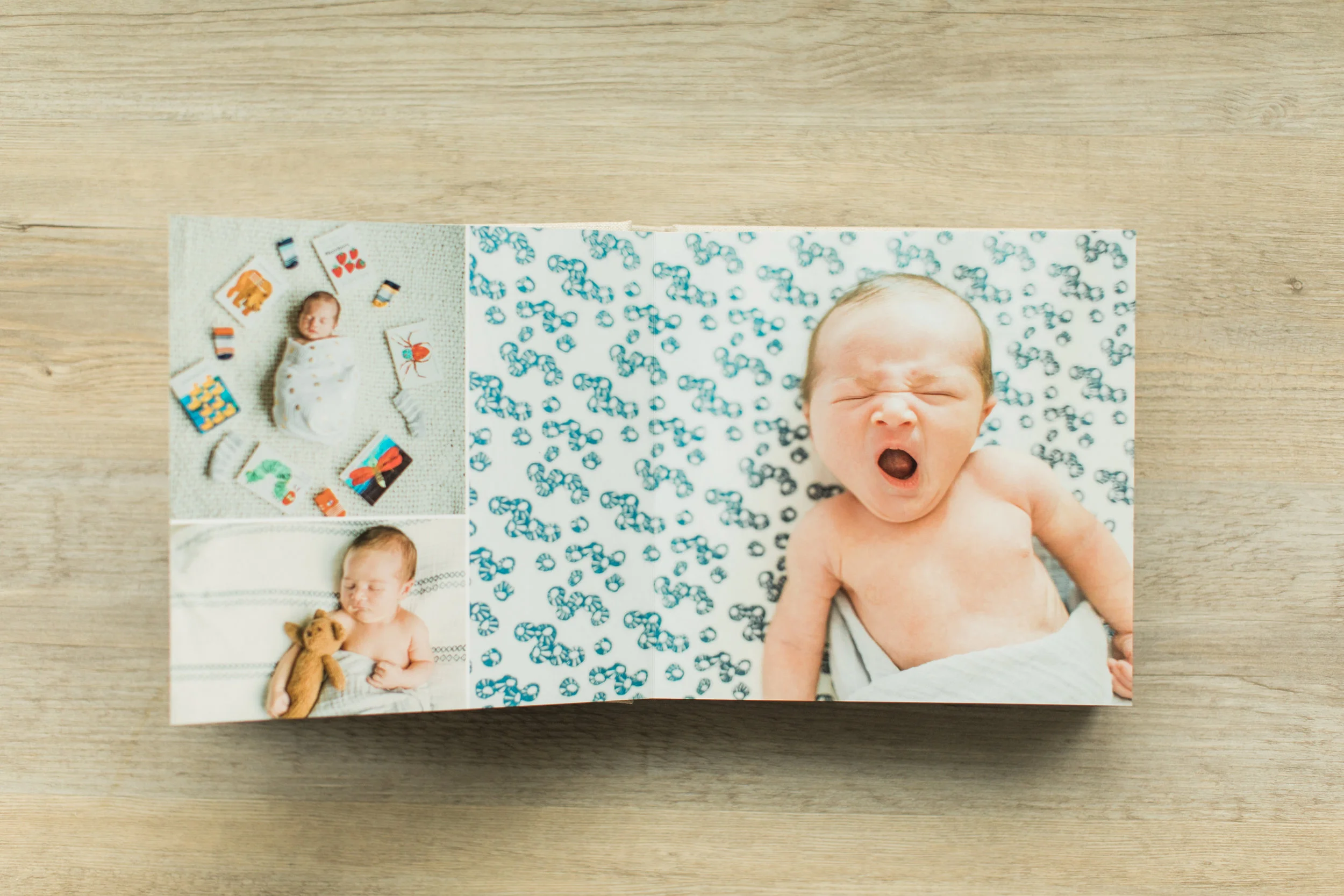 A photo of a baby yawning is inside of a baby photo album.