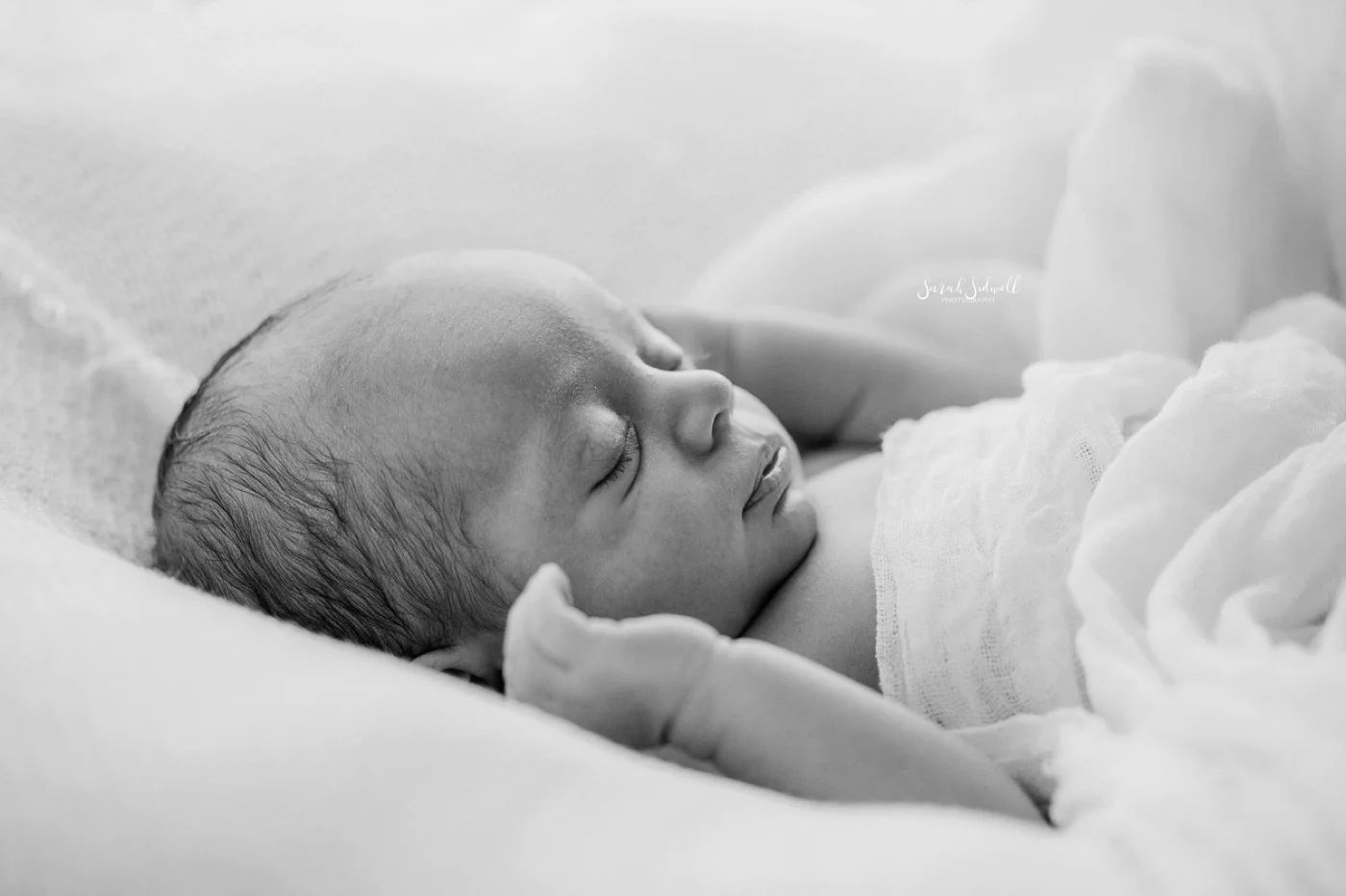 A new baby stretches in his sleep.