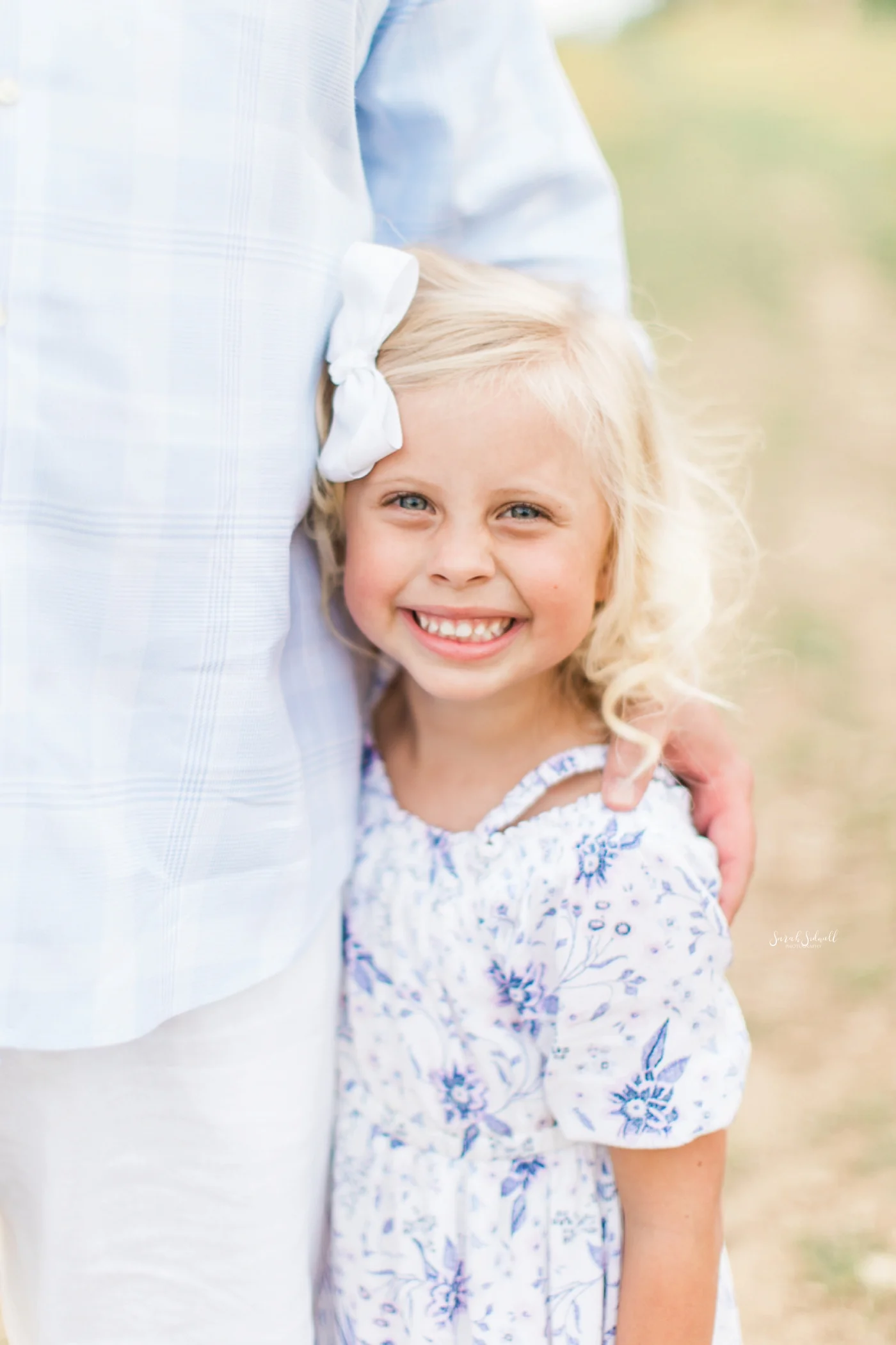 A girl hugs her dad during some family photography photos.