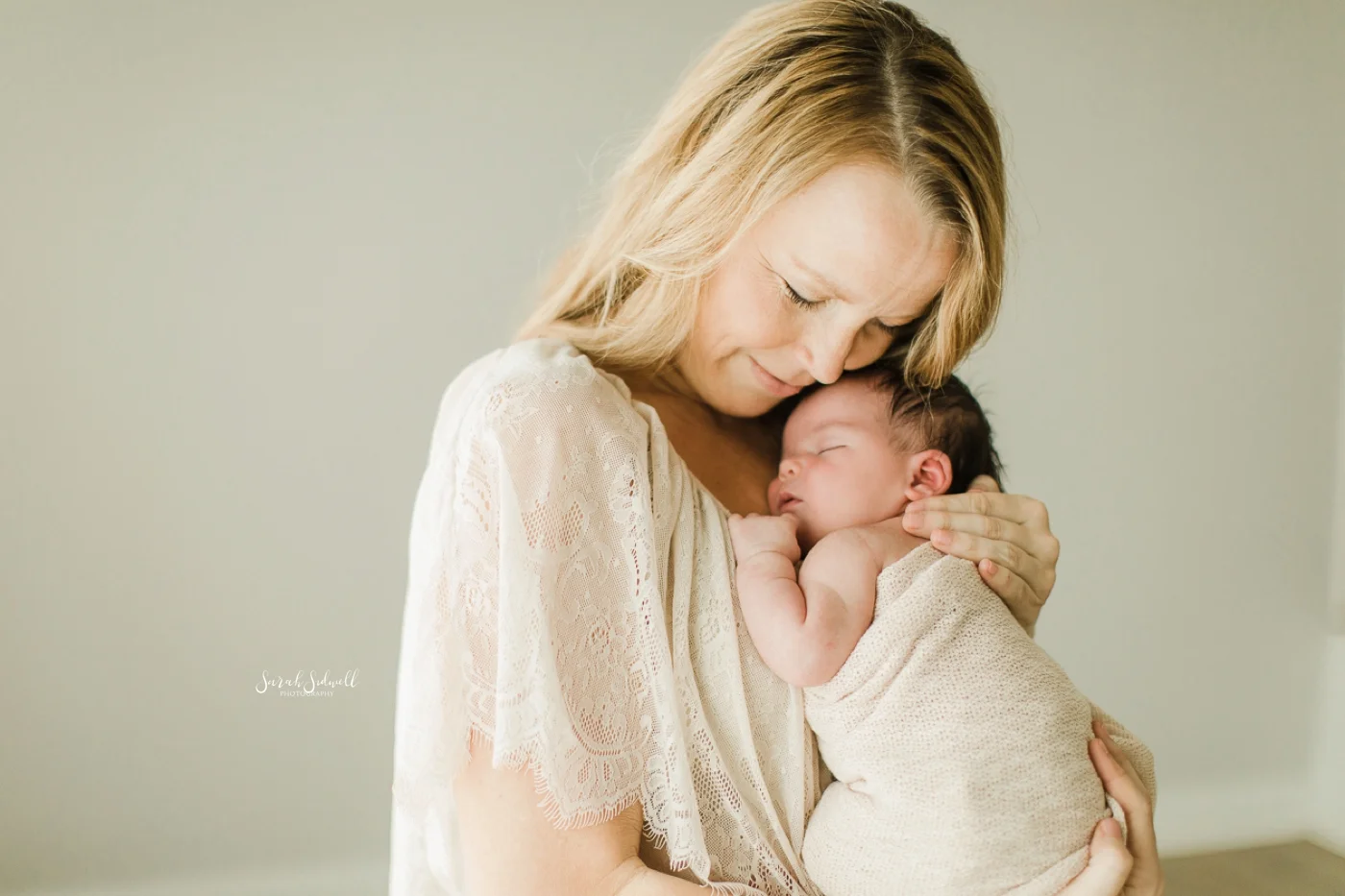 A newborn sleeps on her mother's chest.