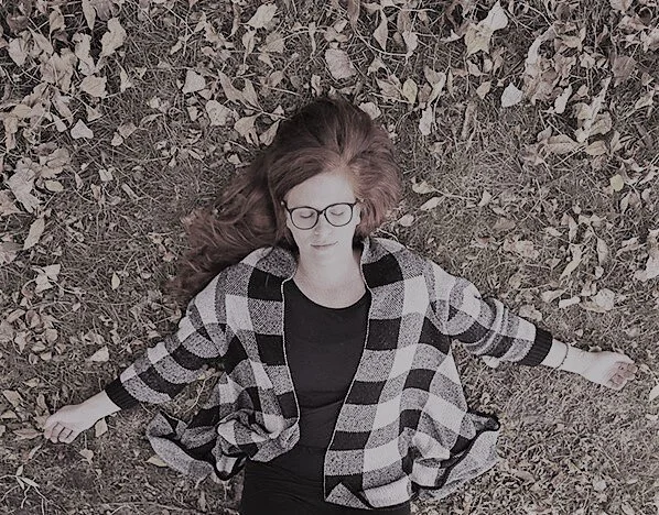 laying in grass and leaves muted.jpg