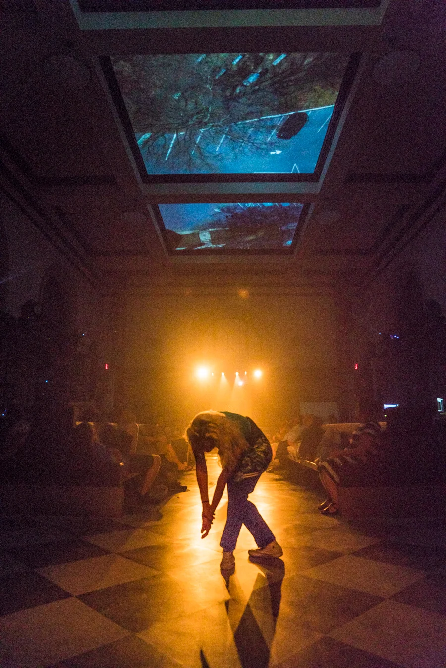 Dancer Samantha Shepherd appears on stage in the Franklin Street terminal beneath the 3 channel film "Soars." Credit: Max Acra