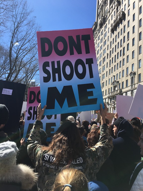 D4D at March For Our Lives with Badlands protest sign and Rachel Comey D4D custom jacket