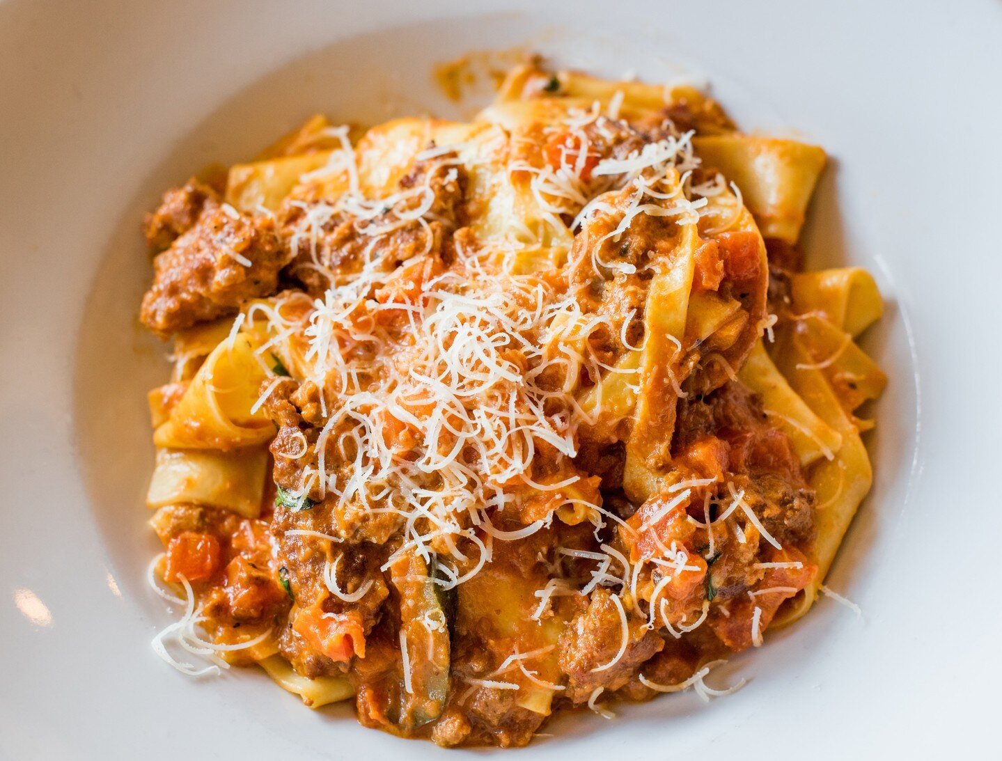 Pappardelle with Italian Sausage &bull; Spicy sausage, plum tomatoes, garlic, herbs, bolognese, cream