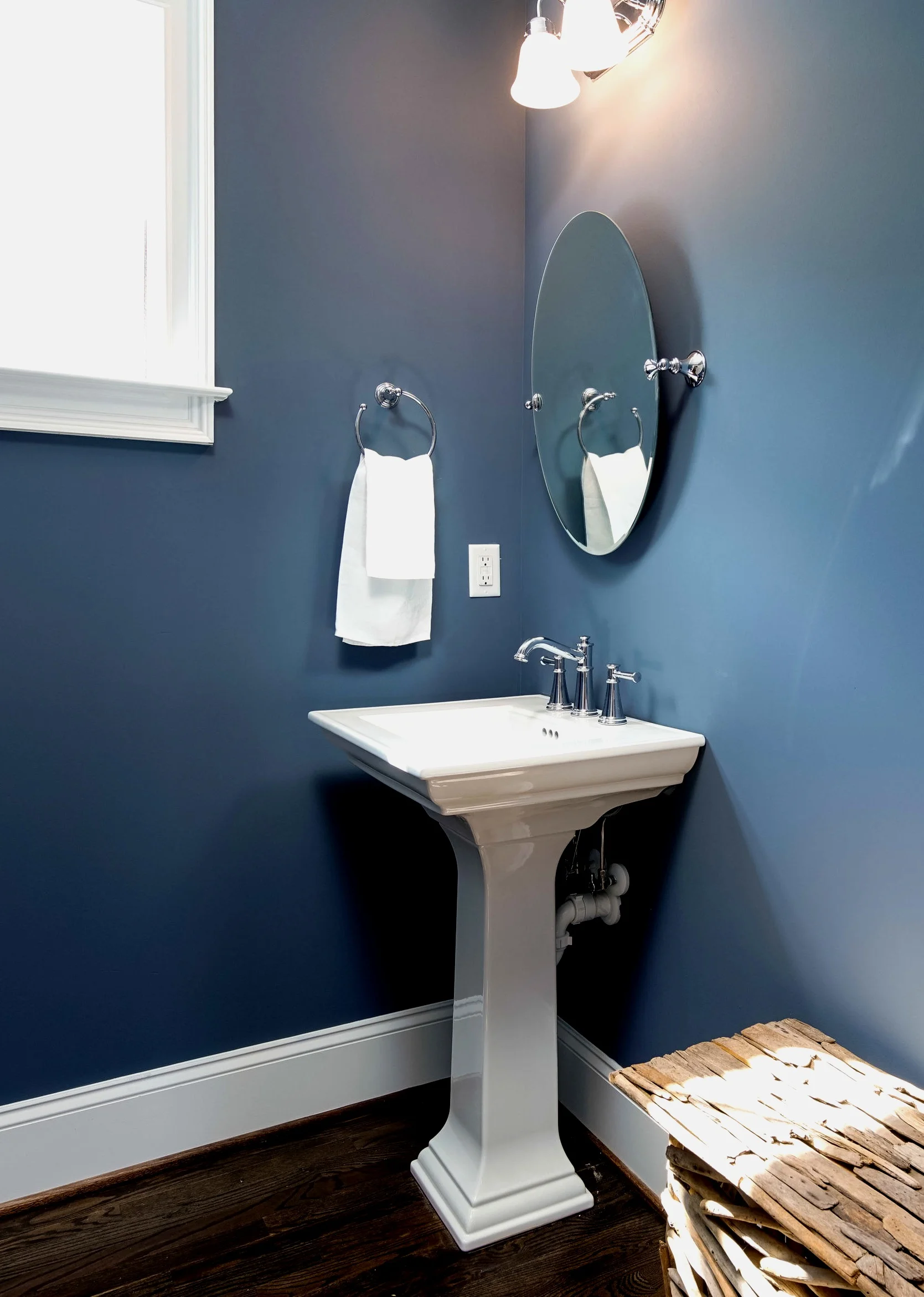 Photo of the powder bath in our custom home project on Tallulah with beautiful deep navy walls.