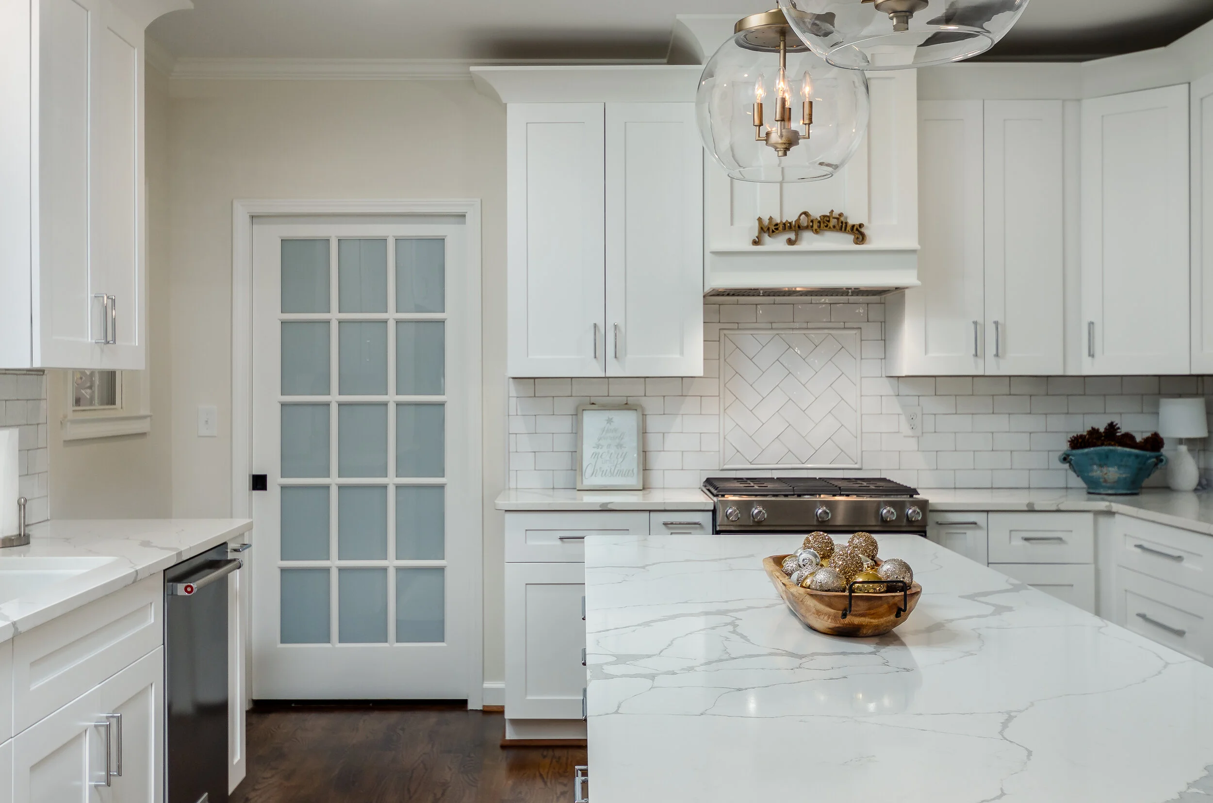 A classic white kitchen with marble veining quartz countertops sets the perfect tone for the home to transform with every season.