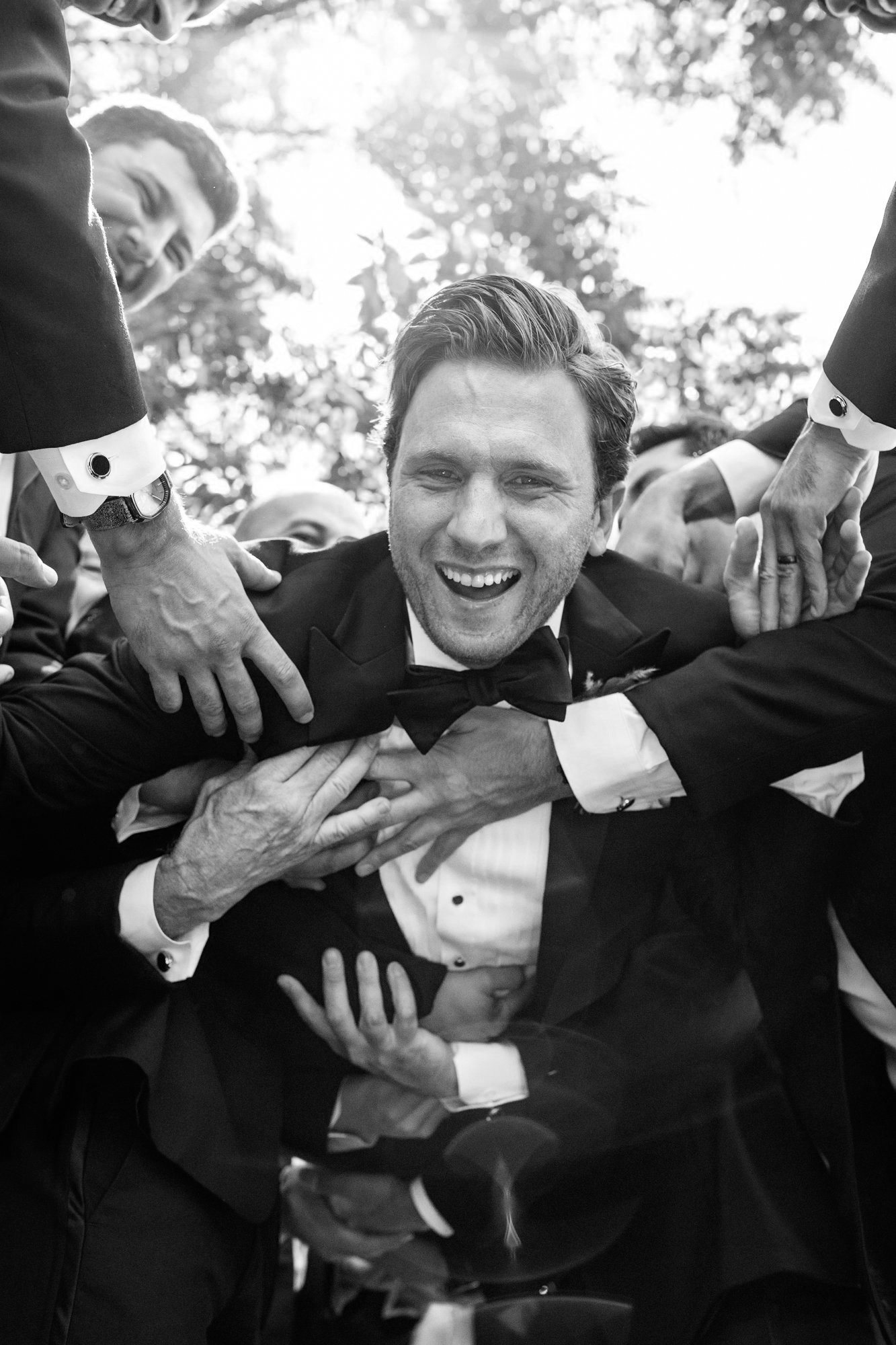 Groom being tossed on his wedding day at the Weatherly Pavillion in Maryland