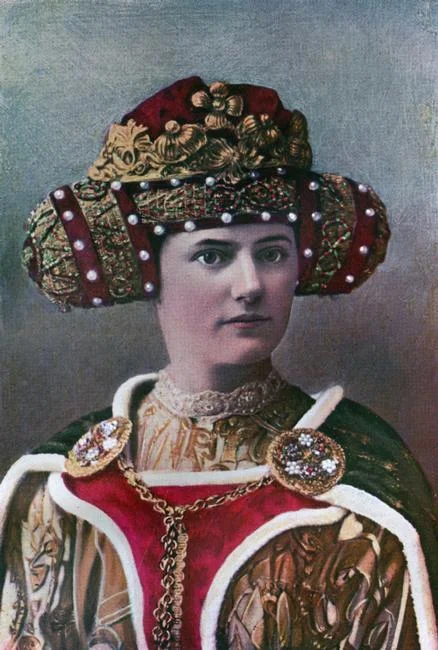 Lady's headdress, 14th century, (1910). Fashion from the reign of Richard II (1377-1399). The reticulated and richly-jewelled headdress is worn with a cote-hardi of purple silk, a super cote-hardi of fur-lined embossed velvet, and a green velvet cloak, edged with ermine and fastened by a morse across the chest. Illustration from British Costume during 19 Centuries by Mrs Charles H Ashdown, (London, 1910). Photo Credit: HIP / Art Resource, NY Image Reference: AR985405