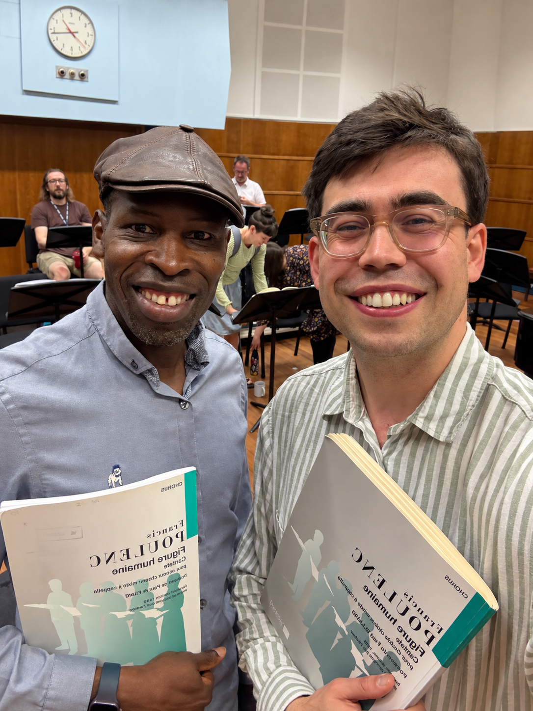 Hervé Goffings with conductor Owain Park in a BBC Singers rehearsal room, holding scores of Poulenc’s Figure humaine in preparation for the Aldeburgh Festival.