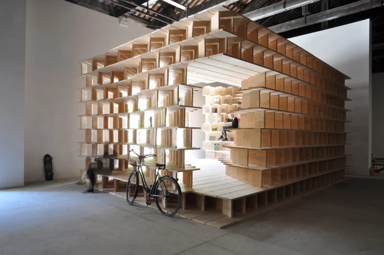 Architects Aljoša Dekleva and Tina Gregorič have built a wooden library inside the Slovenian Pavilion at the Venice Architecture Biennale that reflects on the role of the ‘home’ today. 