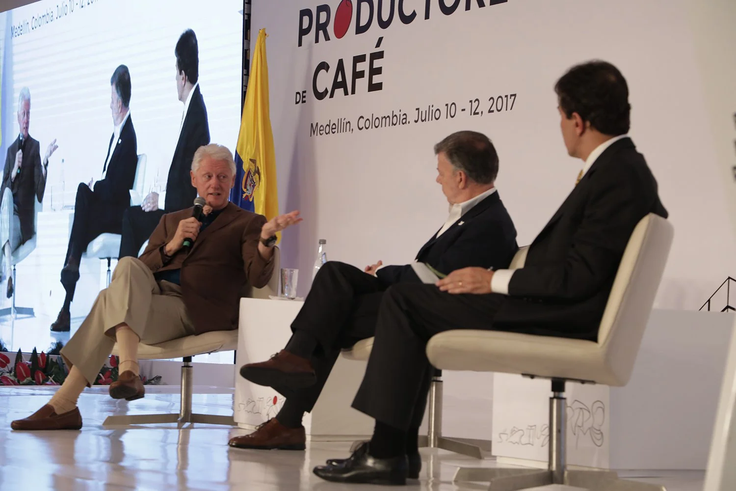 Former US President Bill Clinton joins Colombia's President Juan Manuel Santos on stage at the first World Coffee Producers Forum in Medellin. 