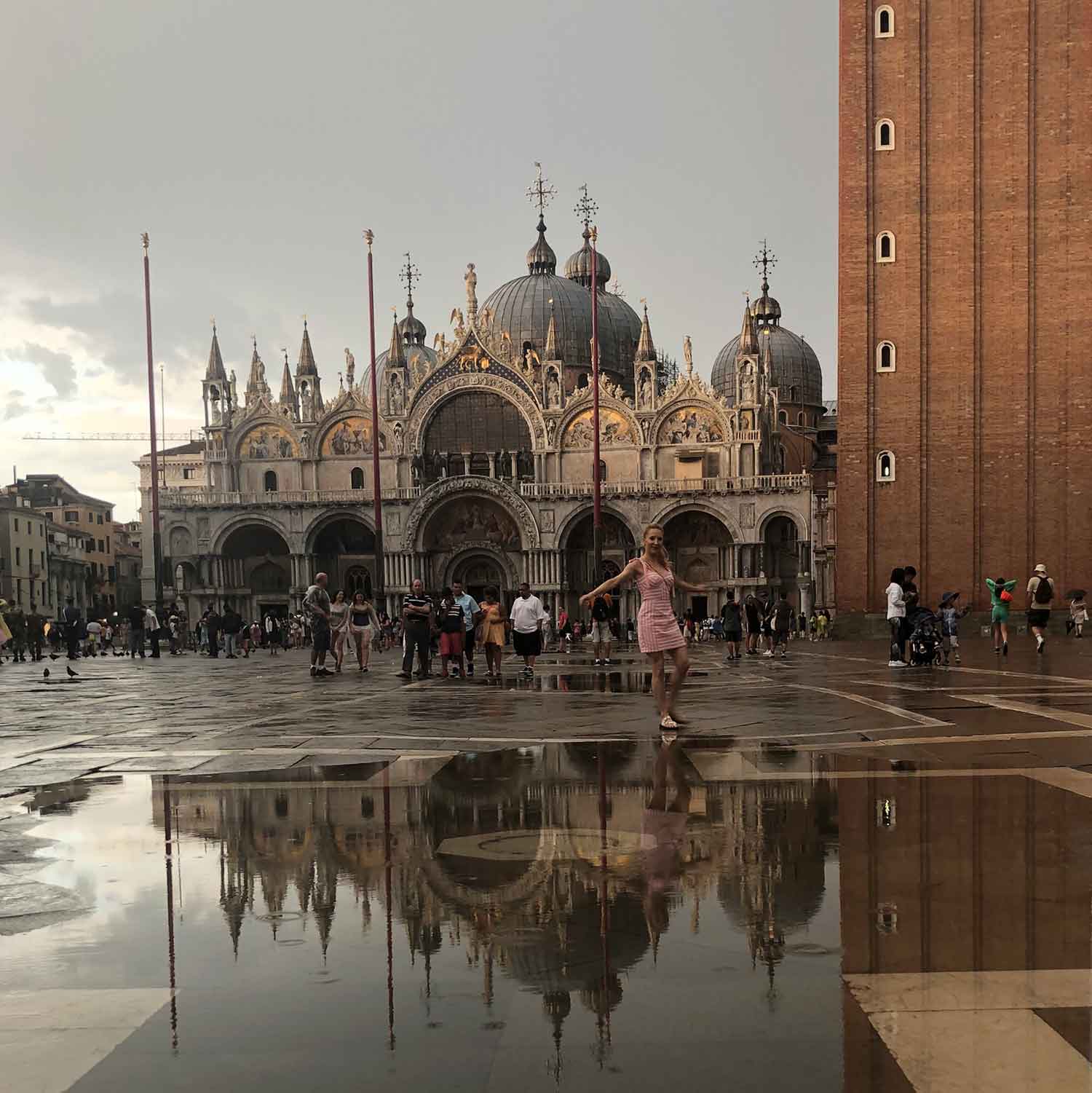 St Marks Square Venice Italy luxury travel blogger Eve dancing in the rain