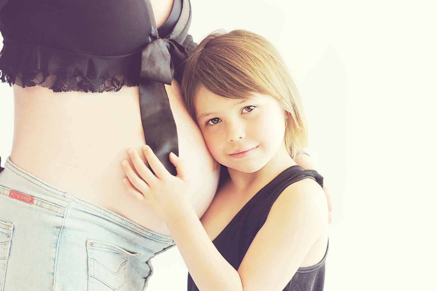 Pregnant woman daughter hug infertility help