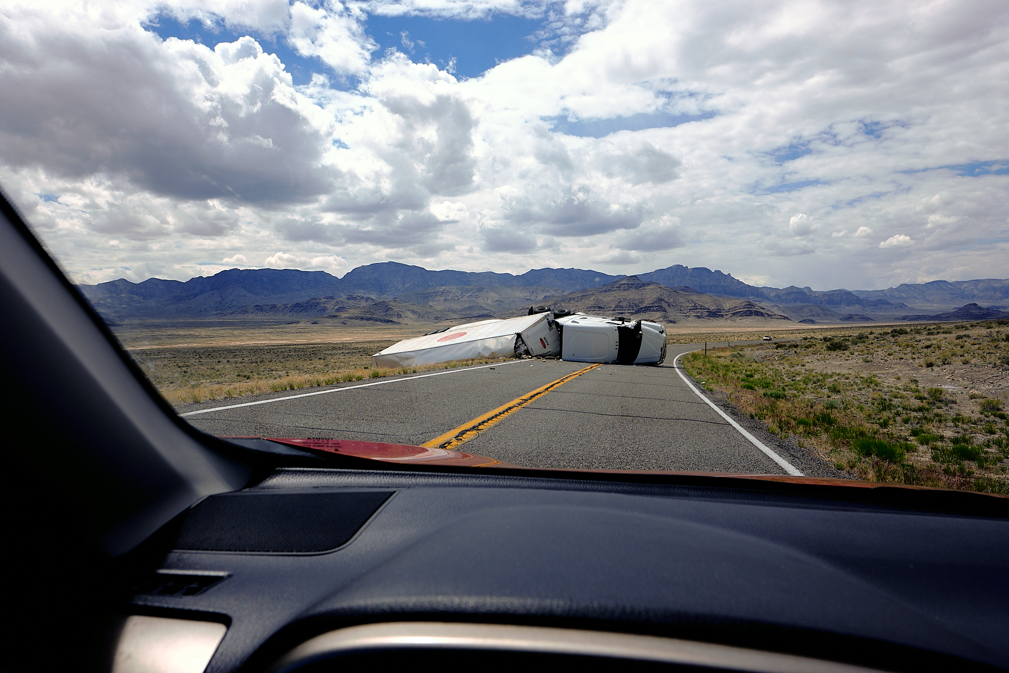  About 60 miles west of Delta, Utah I was the second car to arrive at a recently flipped truck. No cell service here so I sped back a few miles to find a whiff of signal while standing on my car to call 911. The nearest officer was 50 miles away. The