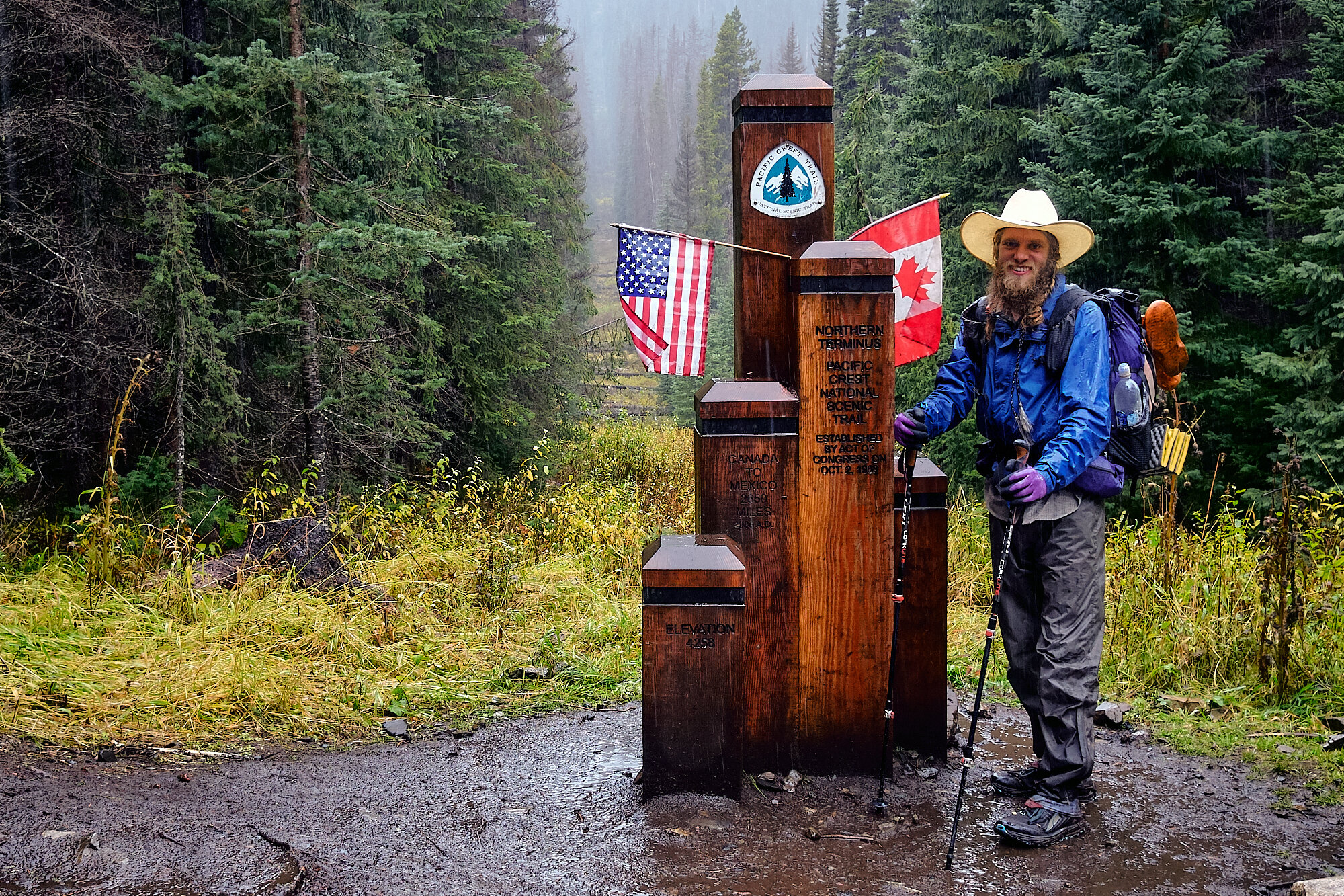  At long last, Canada! The line cut through the trees behind the monument is the border. Celebrations didn't last long as the temperature dropped and the rain fell harder. | 10/7/19 Mile 2,652.6, 4,258' 