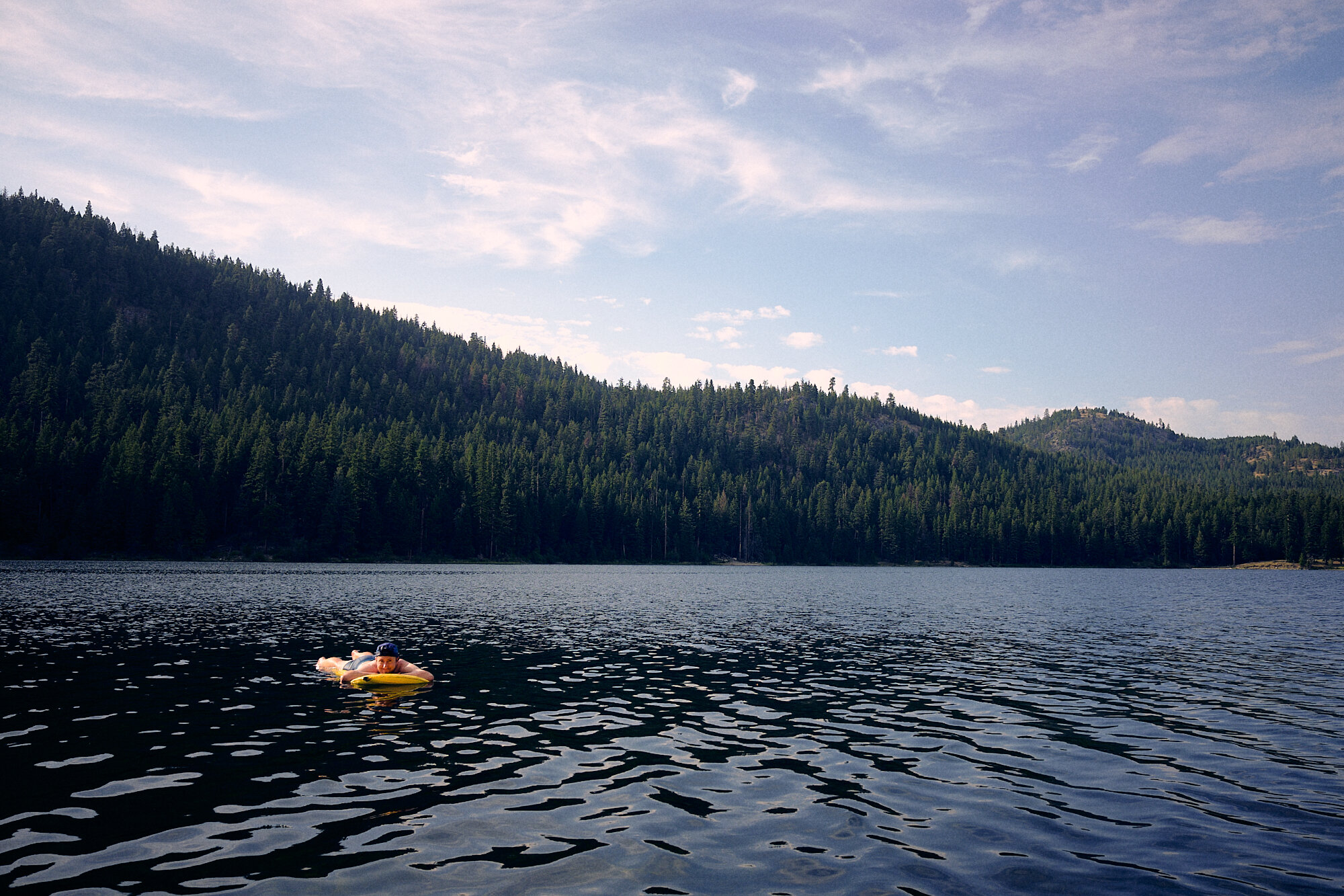  Blankie takes advantage of his extra-wide sleeping pad and goes for a float on Lake Bonaparte. Less than a week later, a fire burned most of the circumference of the lake and surrounding mountains. | 7/28/21 Mile 549.7 3,551' Okanogan Highlands, Was