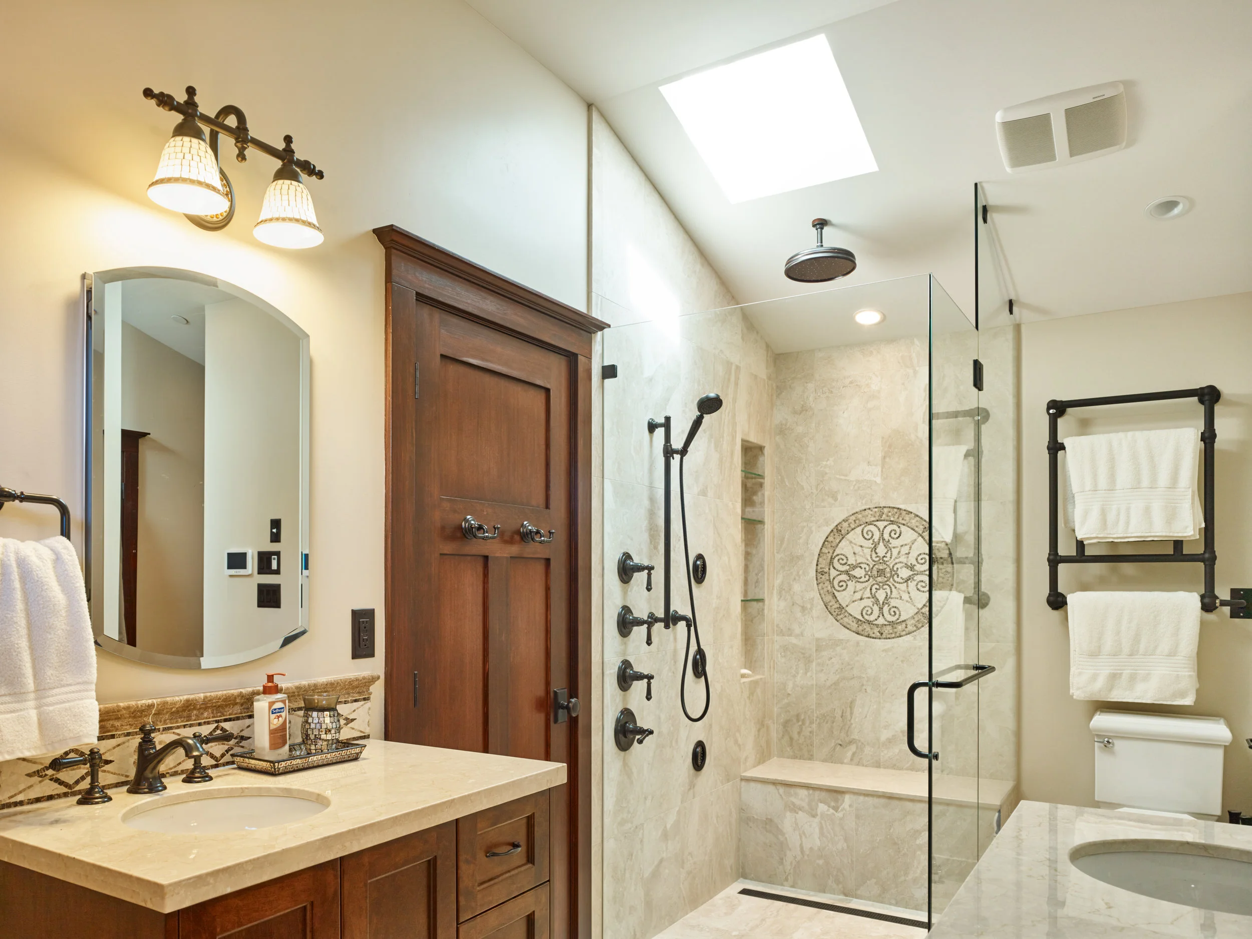 Stand alone shower with a built in seat, rain-head and a skylight keep the ensuite feeling open. A radiant-heated rack keeps a warm towel at arms length. 