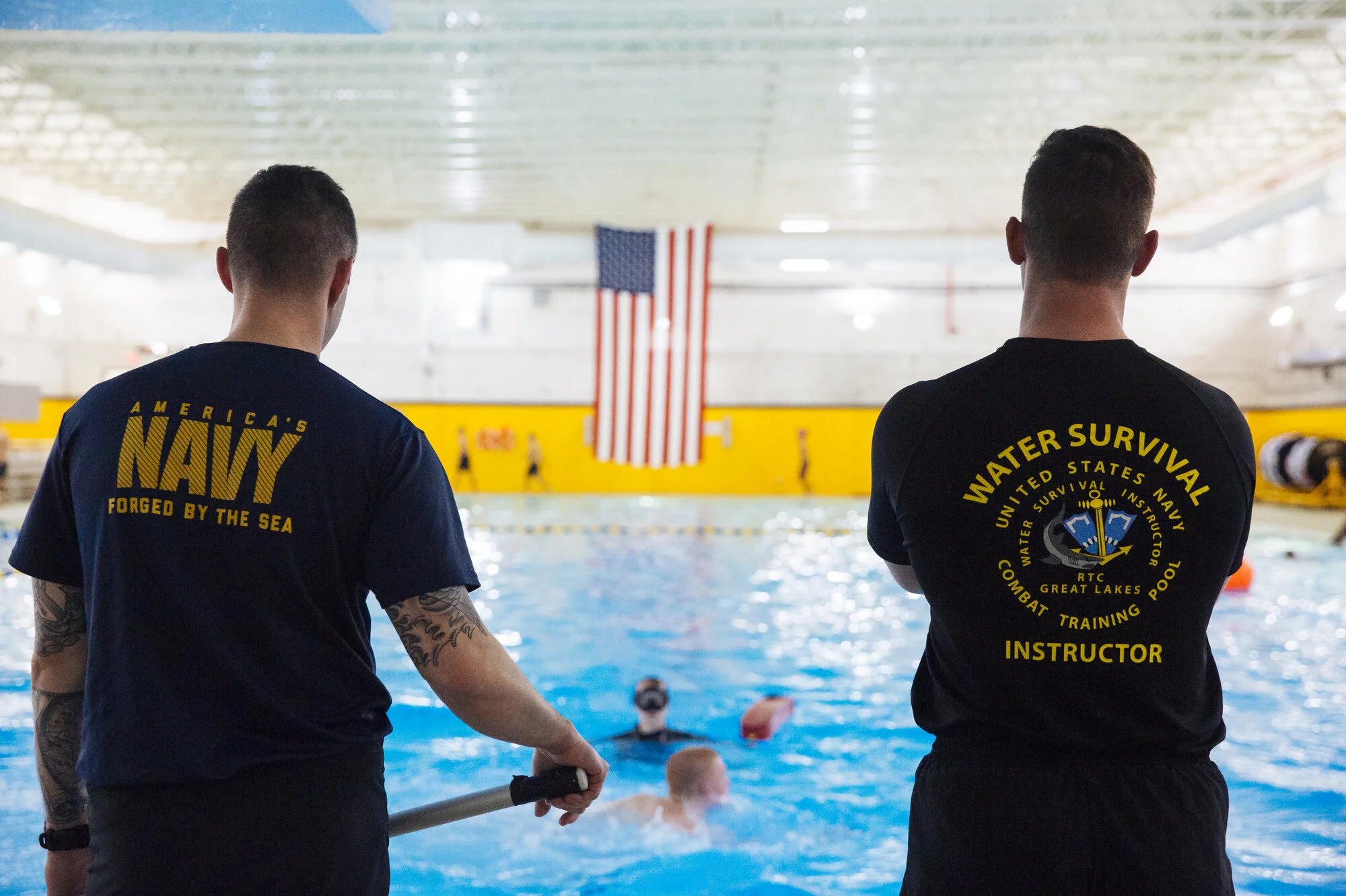  Instructors stand by as recruits step from a high tower into the pool at Naval Station Great Lakes on Wednesday Feb. 12, 2020 in North Chicago, Ill. CREDIT: Taylor Glascock for The Wall Street JournalCSBOOTCAMP 