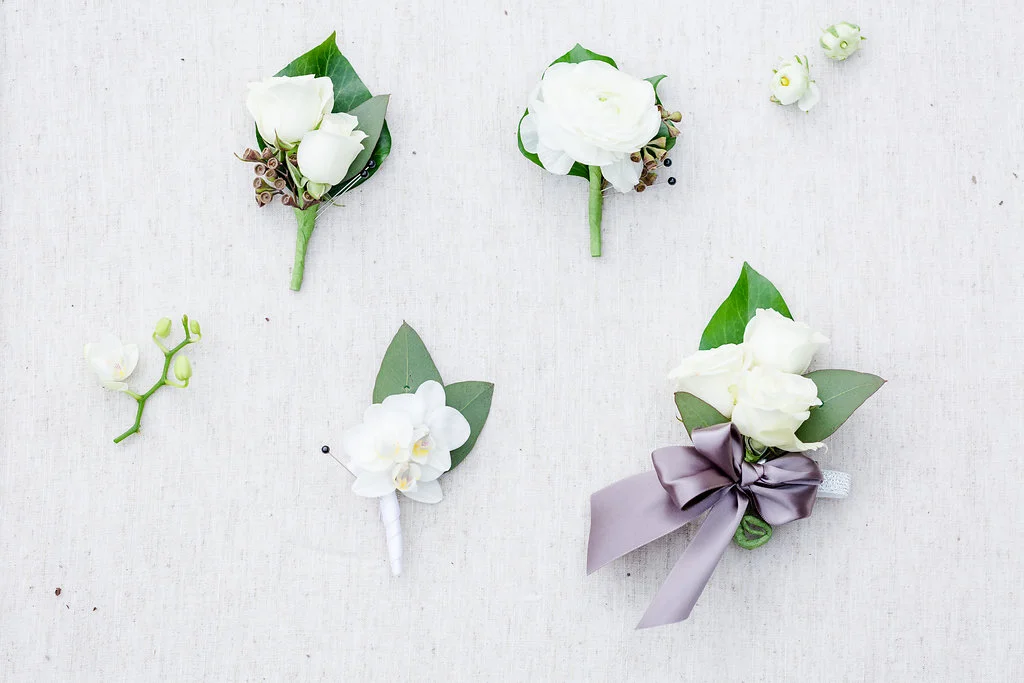How the boutonnieres compare with a traditional wrist corsage. Rachael E.H. Photography