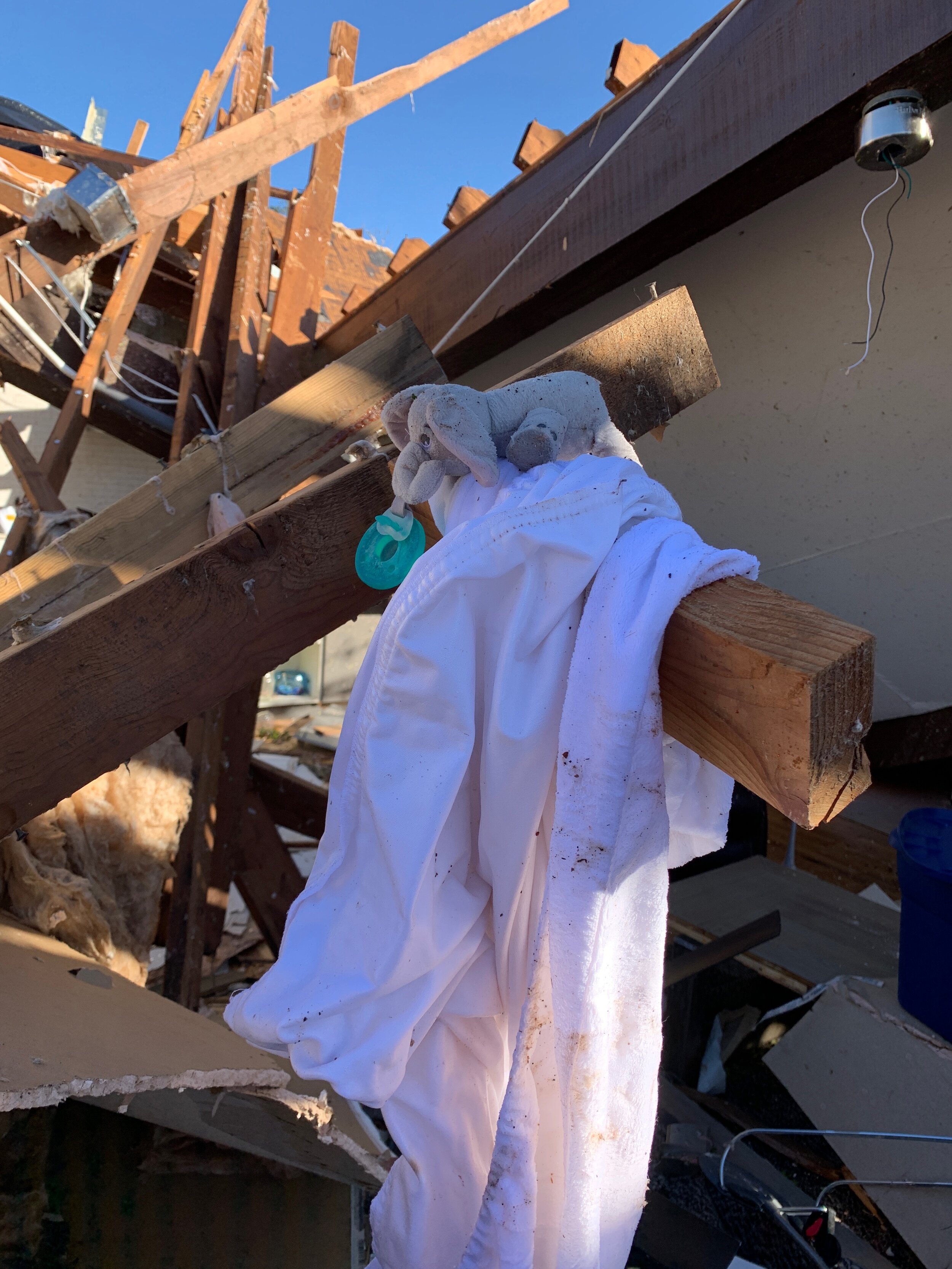  A pacifier and baby blanket weathered the storm and landed among the debris.    