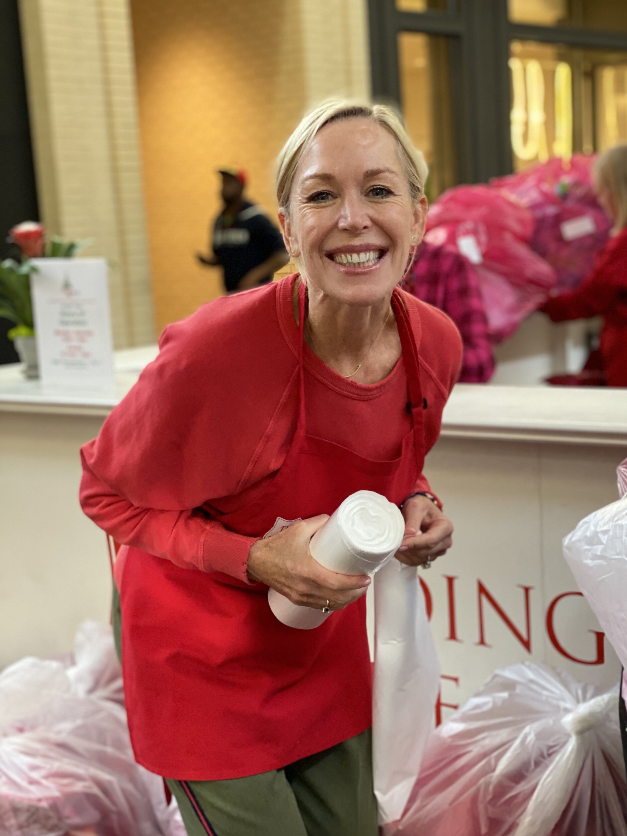 Martha Johnston joyfully packaging the gifts to be transported to the Salvation Army Headquarters. 