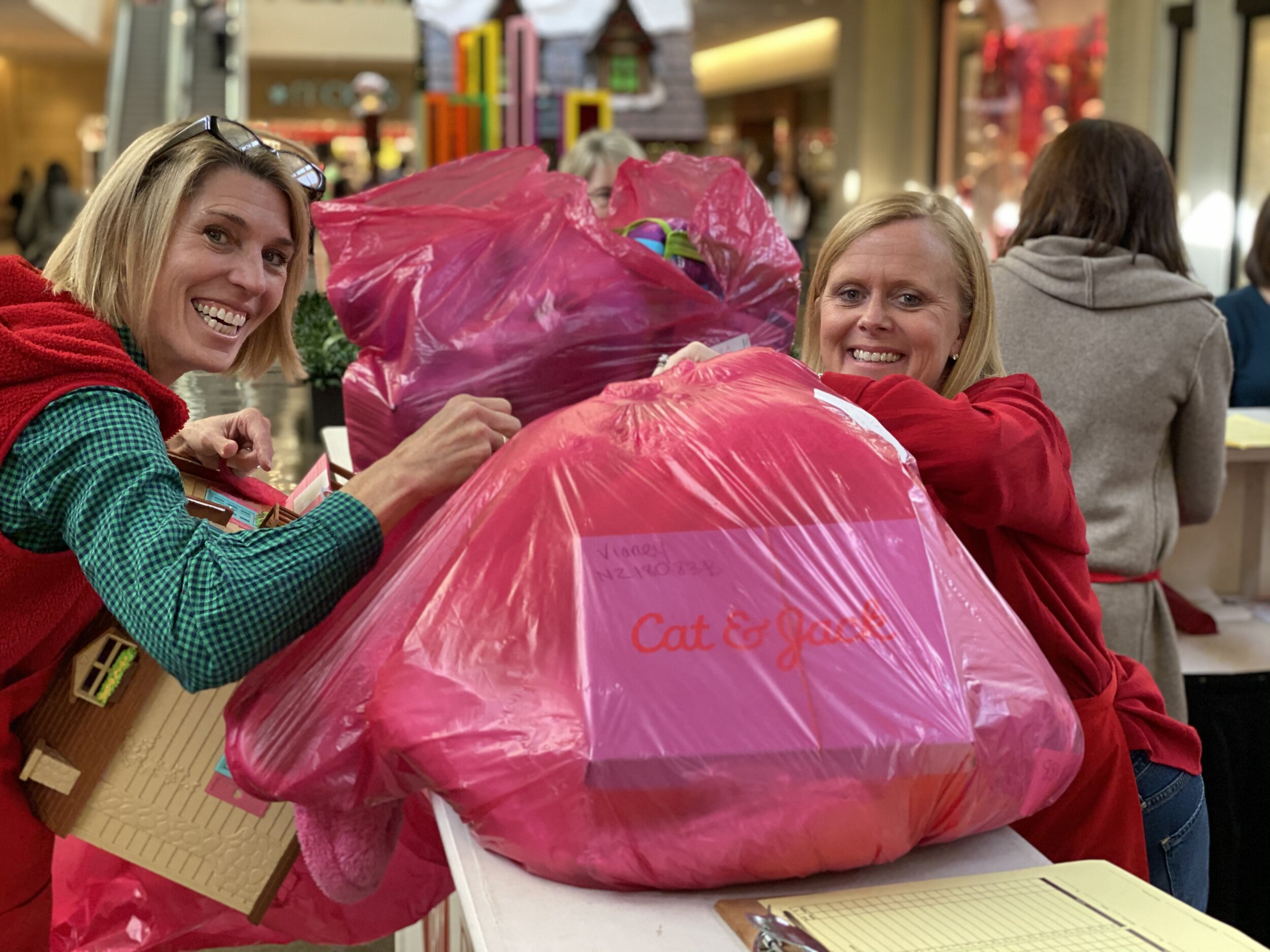  Paula Hayes and Cathy MacDowell checking in gifts for Angel Tree recipients. Paula invited friends from her tennis team to join her in volunteering seven years ago. Paula said that the group had so much fun that we add it to our calendar every year.