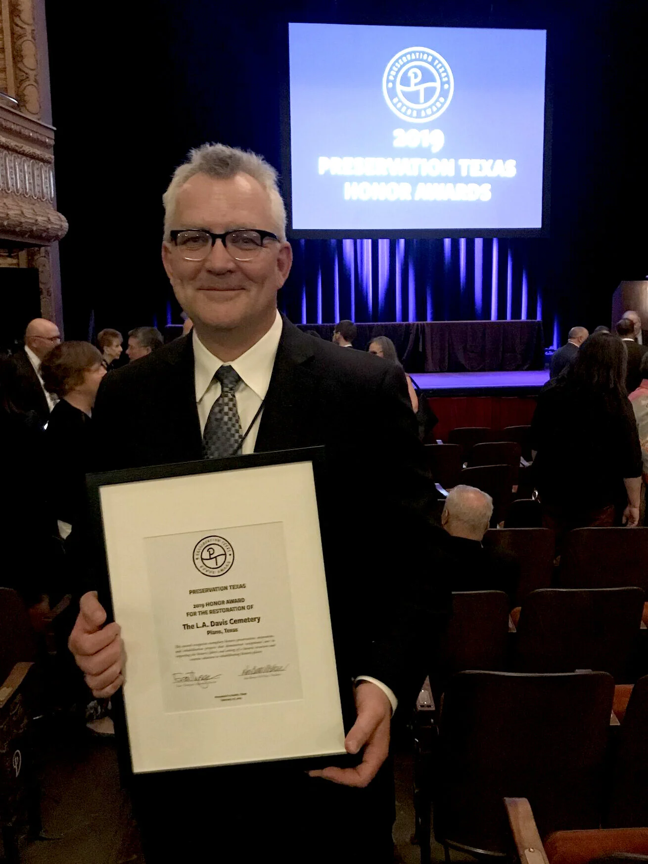 Jeff Campbell with a 2011 Preservation Texas Honor Award for the Plano Conservancy’s work in Davis Cemetery.