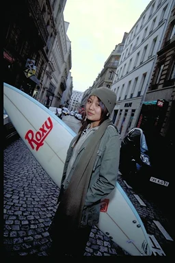 Mymy with Surfboard on Cobblestones