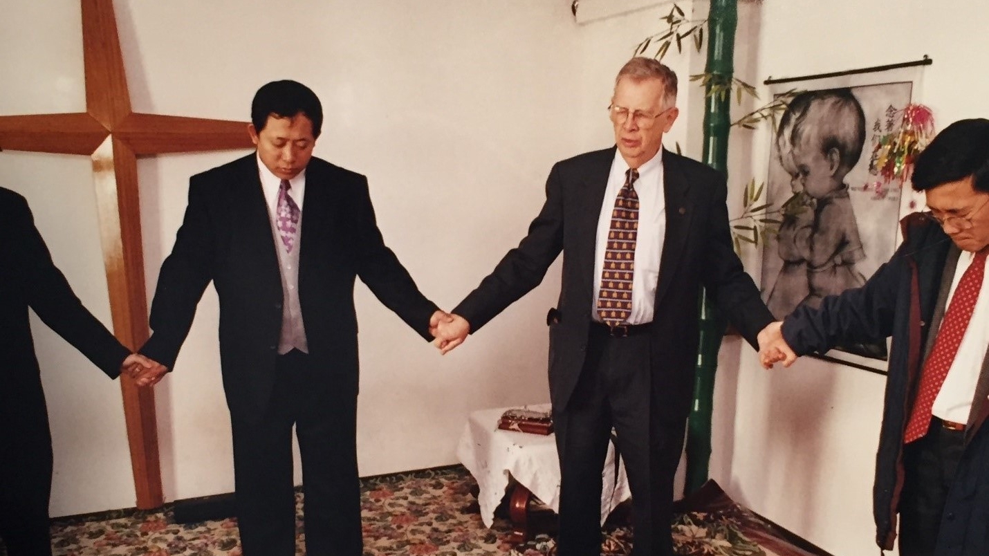 David Bridgman praying with the church in Harbin, China