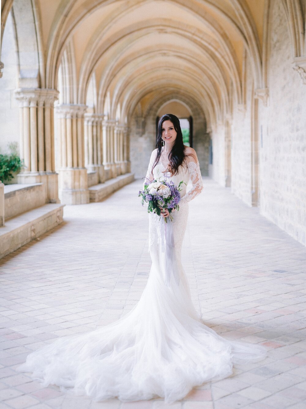  Mallory’s bridal look for her French Destination Château Wedding at Château du Vivier - neutral glamour eyes and peachy lip color with dark brown loose wavy hair, wearing her wispy long sleeved mermaid style wedding dress. Make up applied by english