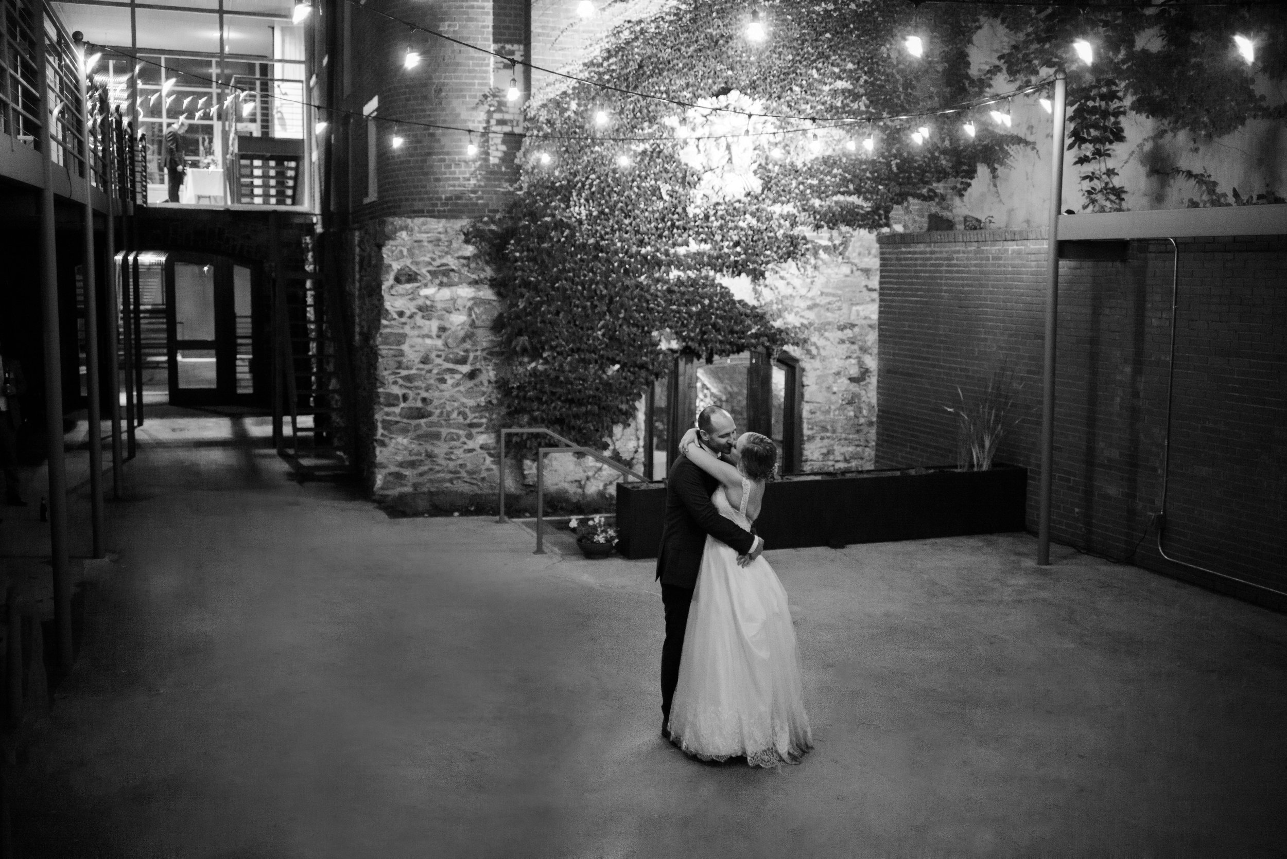 Bride and groom dancing in Garden Courtyard in black and white