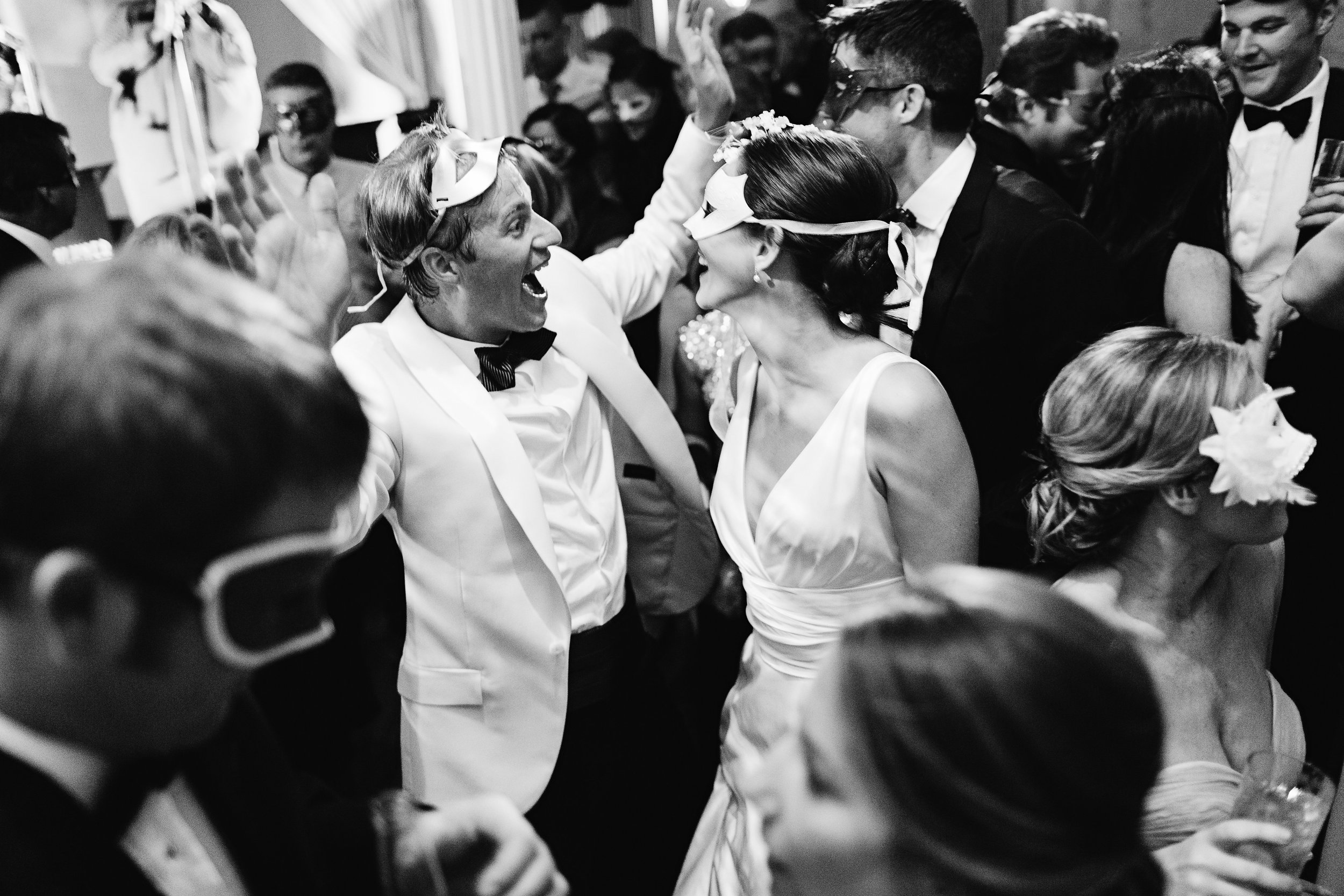 Bride and groom dancing on packed dance floor