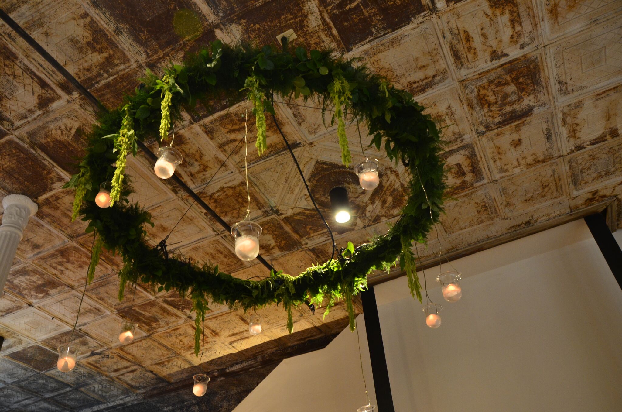 Hanging greenery and bulb chandelier