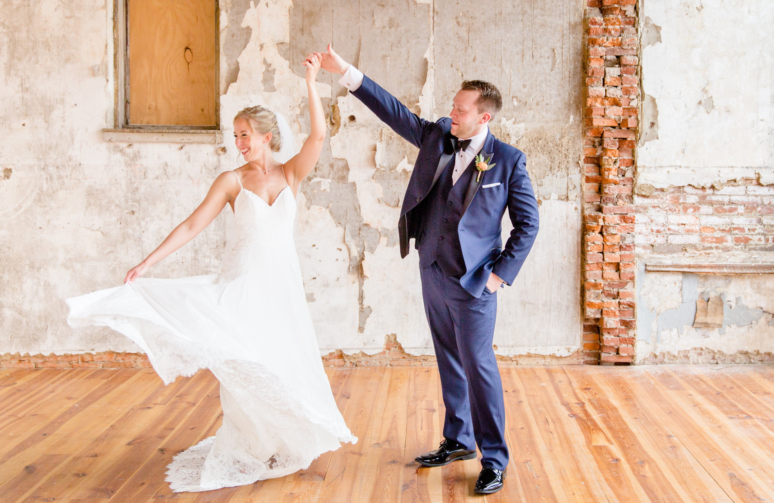 Bride and groom dancing in antique rustic space at Excelsior event venue