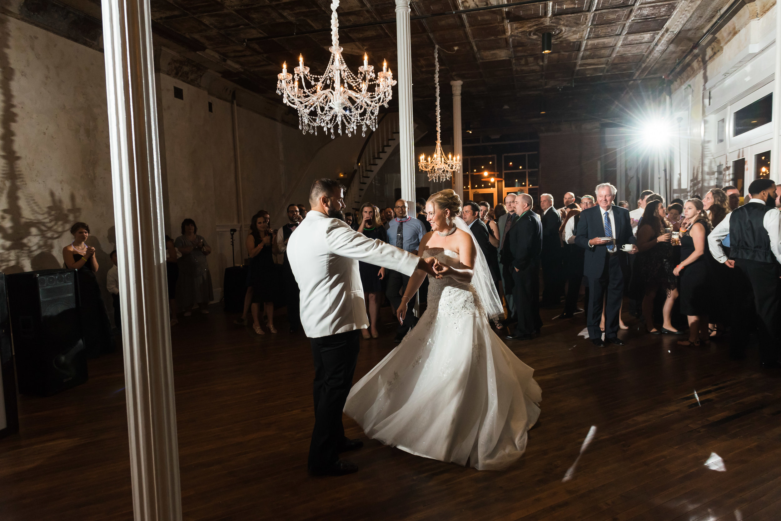 Bride and groom dancing in Grand Salon chandelier