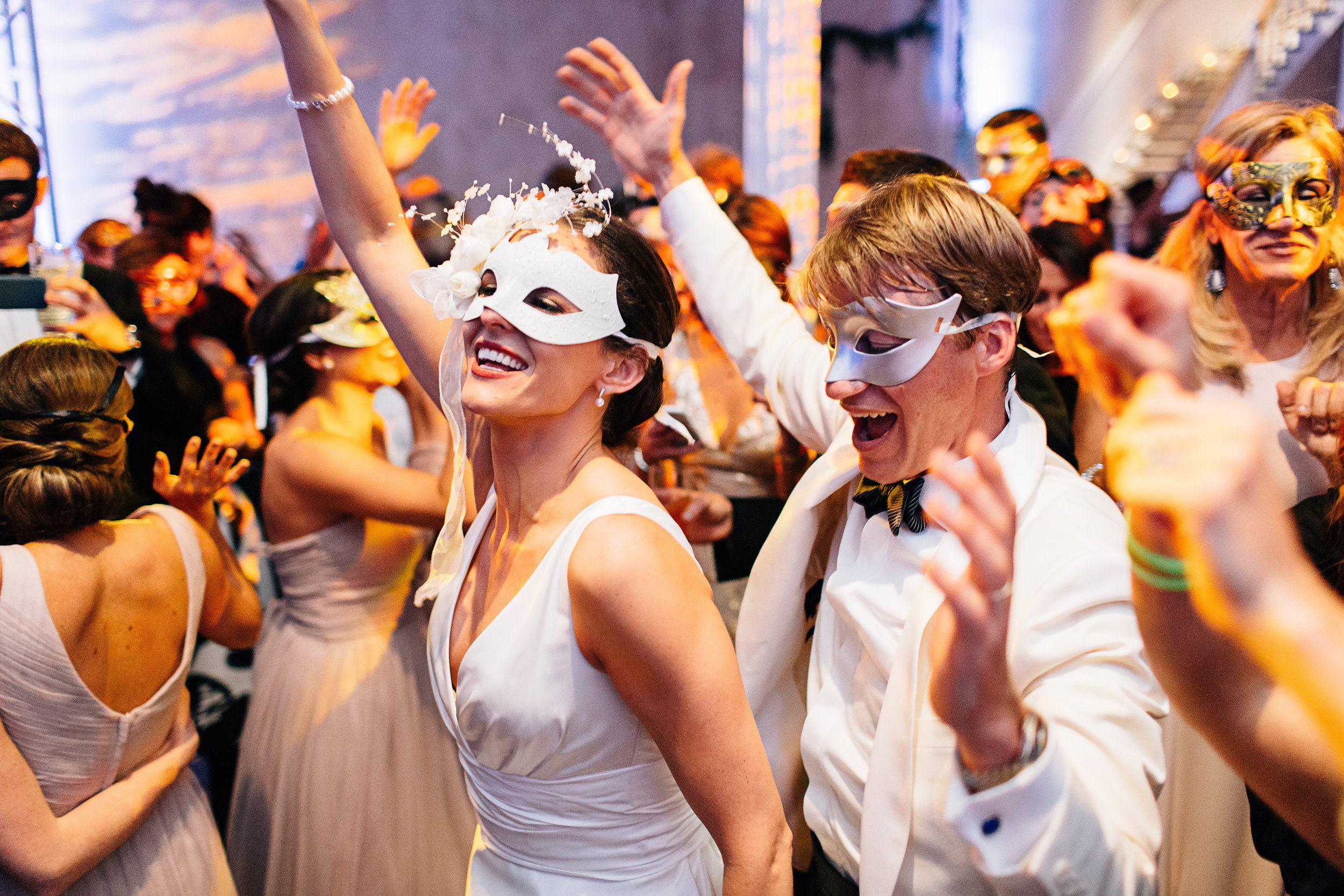 Bride and groom dancing wedding reception with masquerade masks on