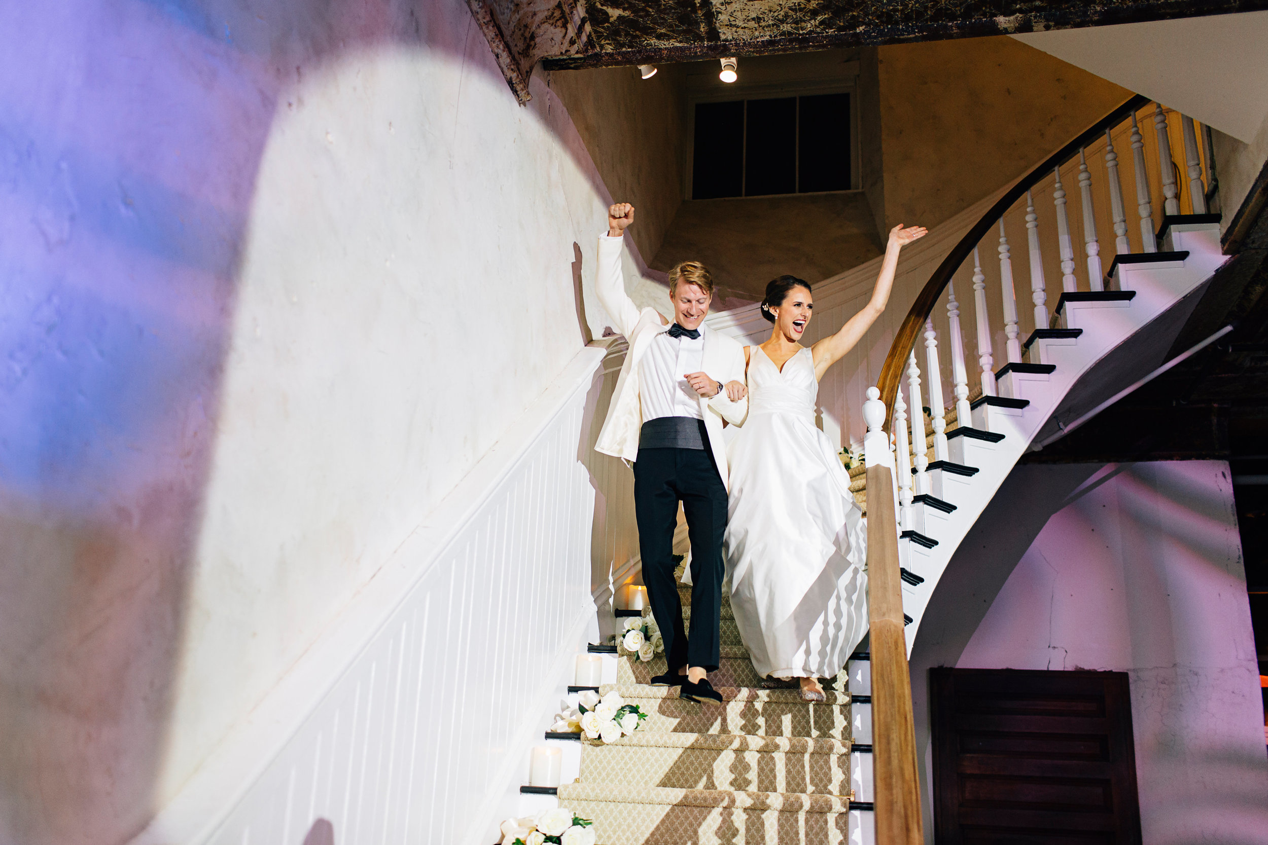 Married couple wedding reception entrance waving with spotlight