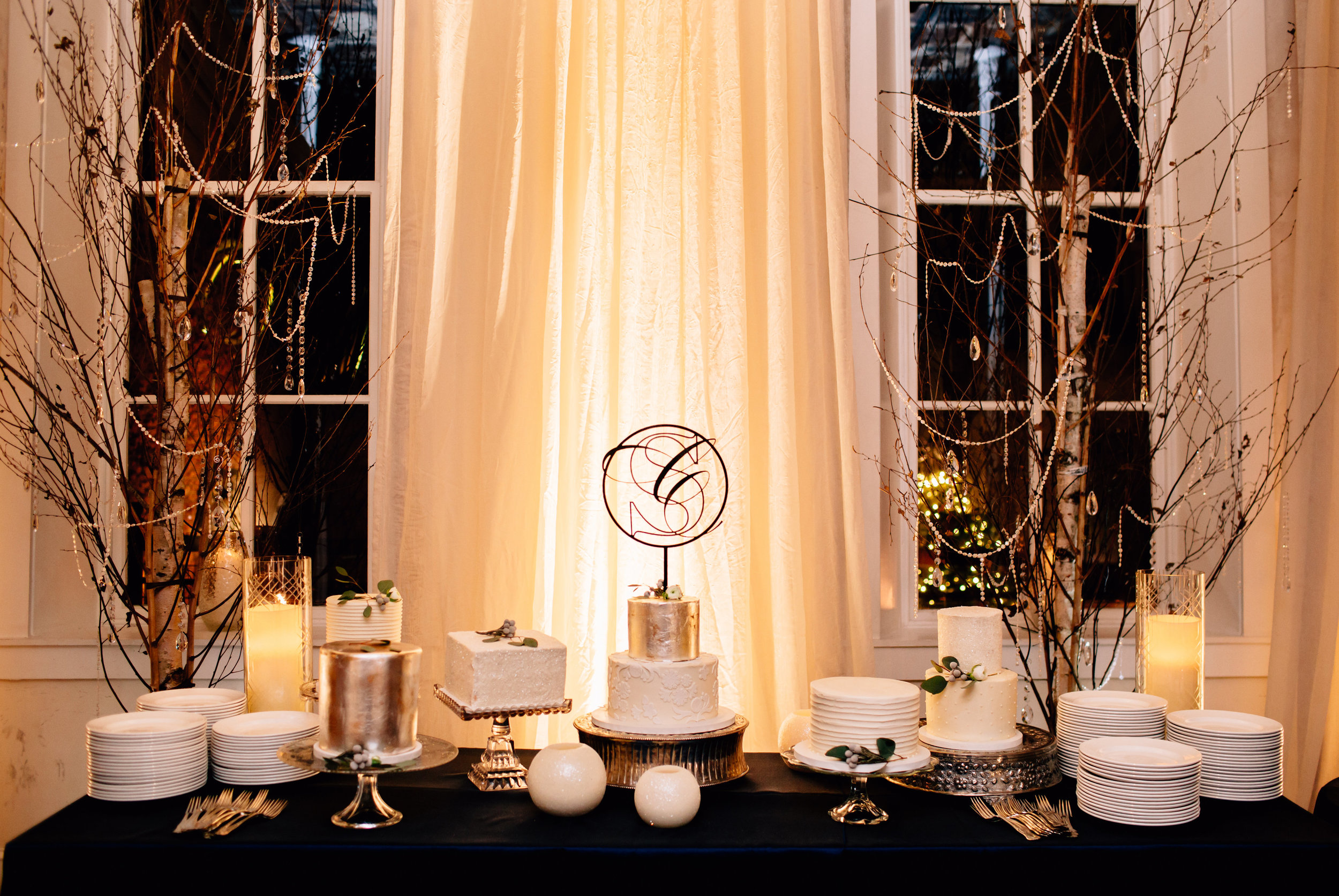 Dramatically lit cake and dessert table wedding reception in Lancaster PA