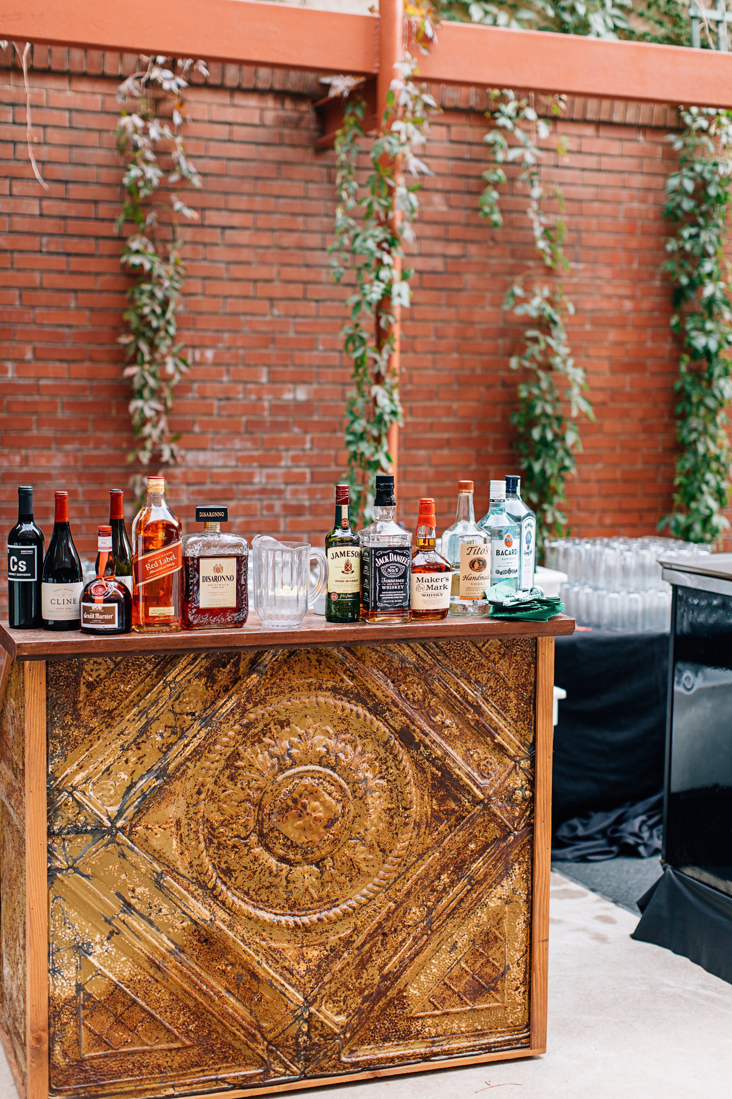 Outdoor bar set up trailing vines on brick wall